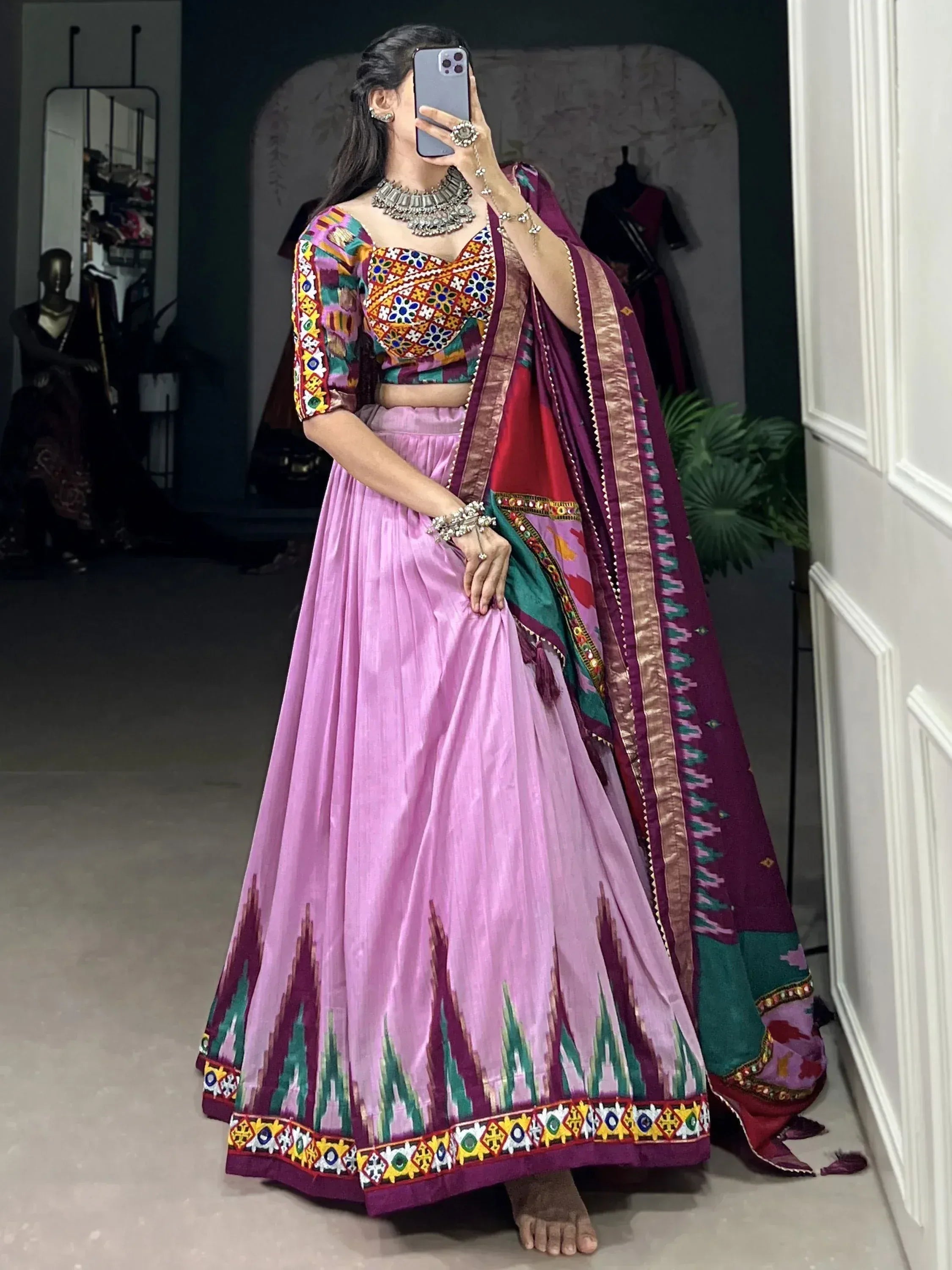 Vibrant pink lehenga choli with colorful embroidery and matching dupatta, perfect for Indian ethnic wear.