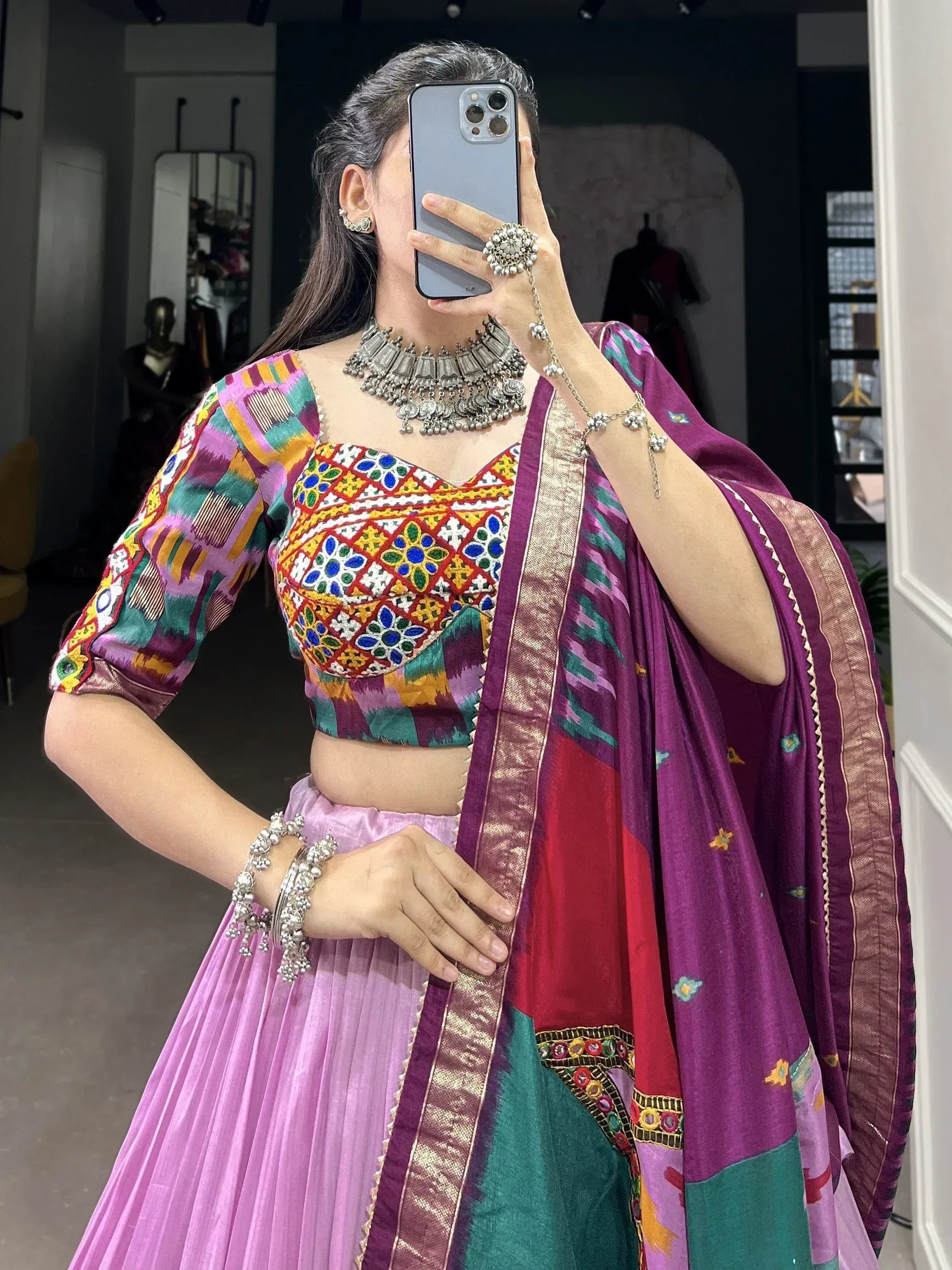 Colorful ethnic lehenga choli with intricate embroidery and traditional jewelry