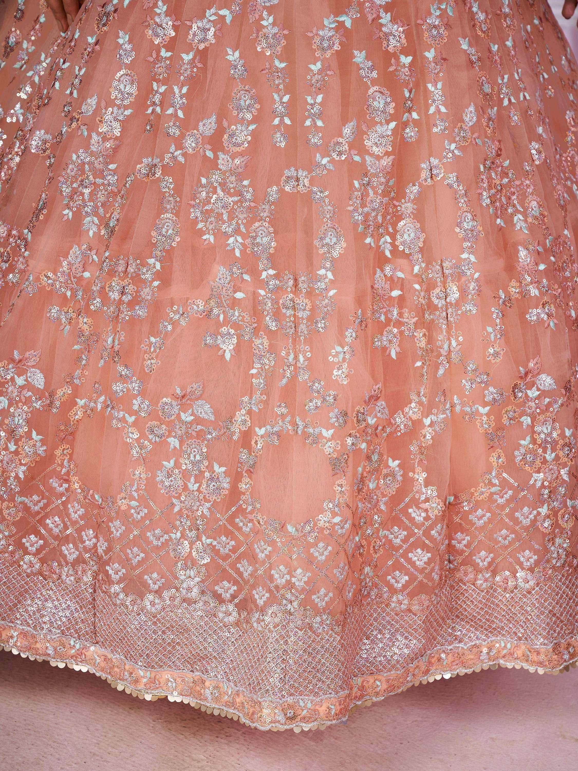 Peach designer lehenga with floral sequin embroidery and scalloped hem, perfect for Indian ethnic wear.
