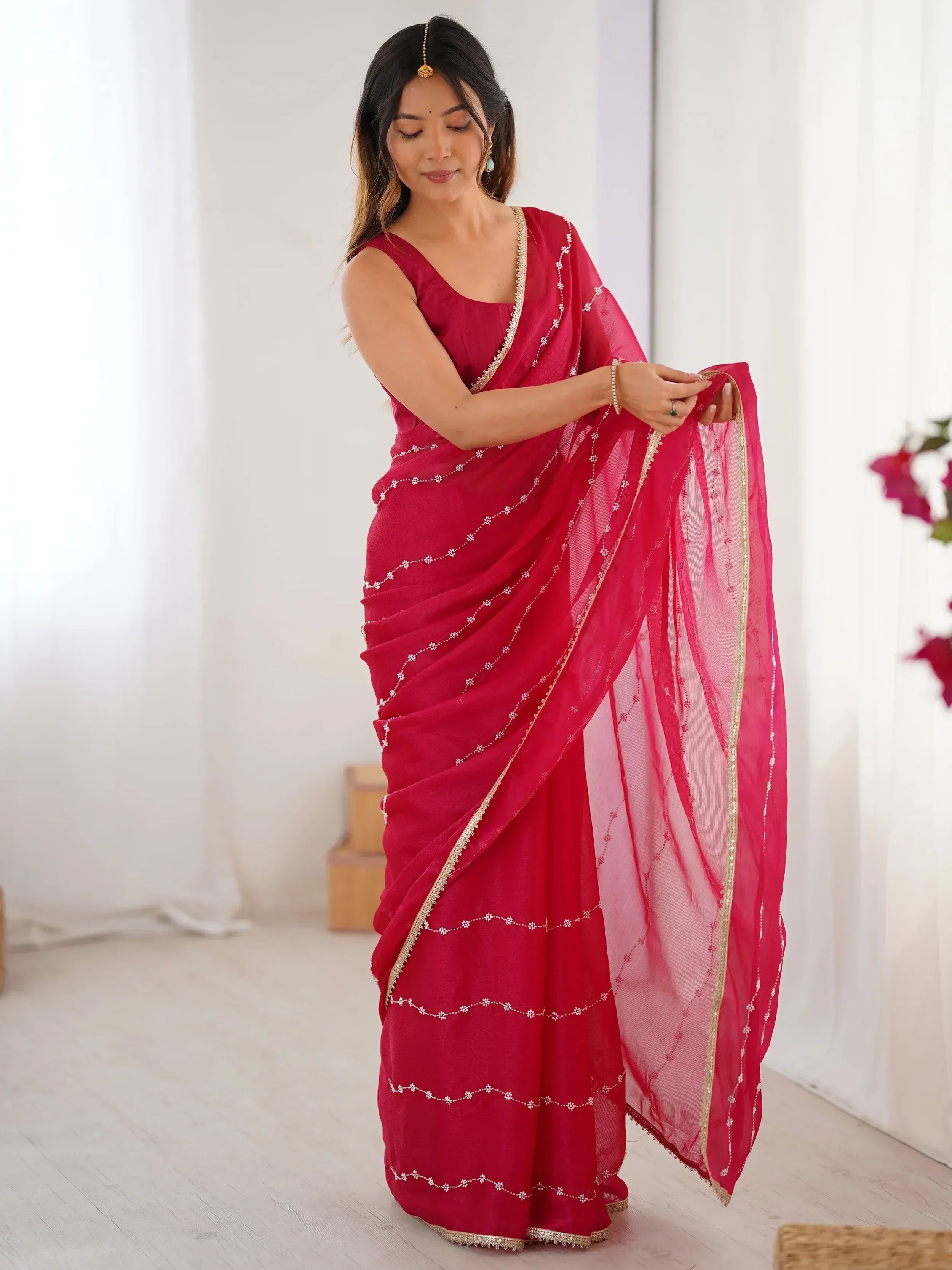 Woman in red embroidered saree with gold trim, Indian ethnic wear