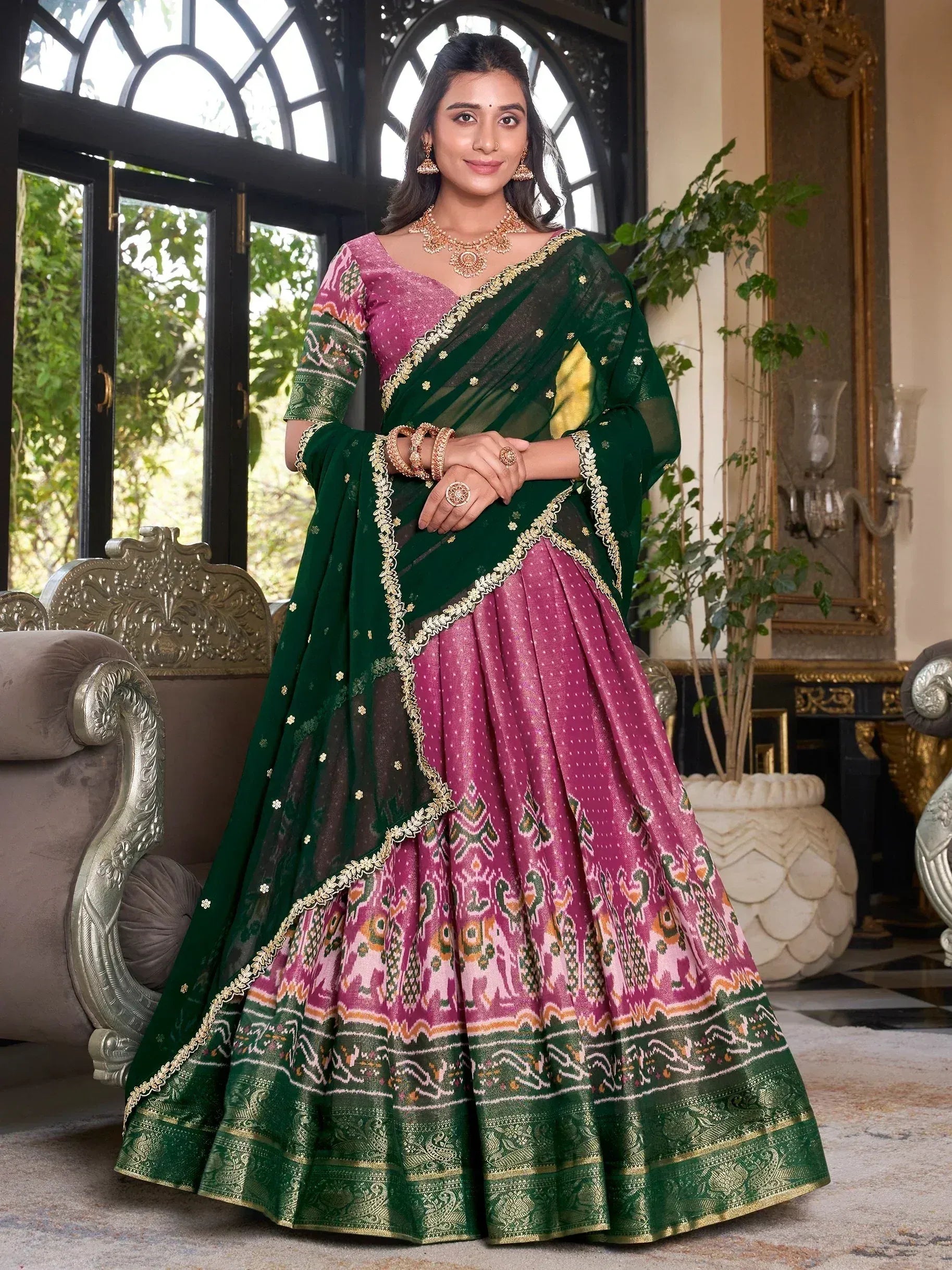 Elegant pink and green designer lehenga choli with gold embroidery, perfect for Indian ethnic occasions.
