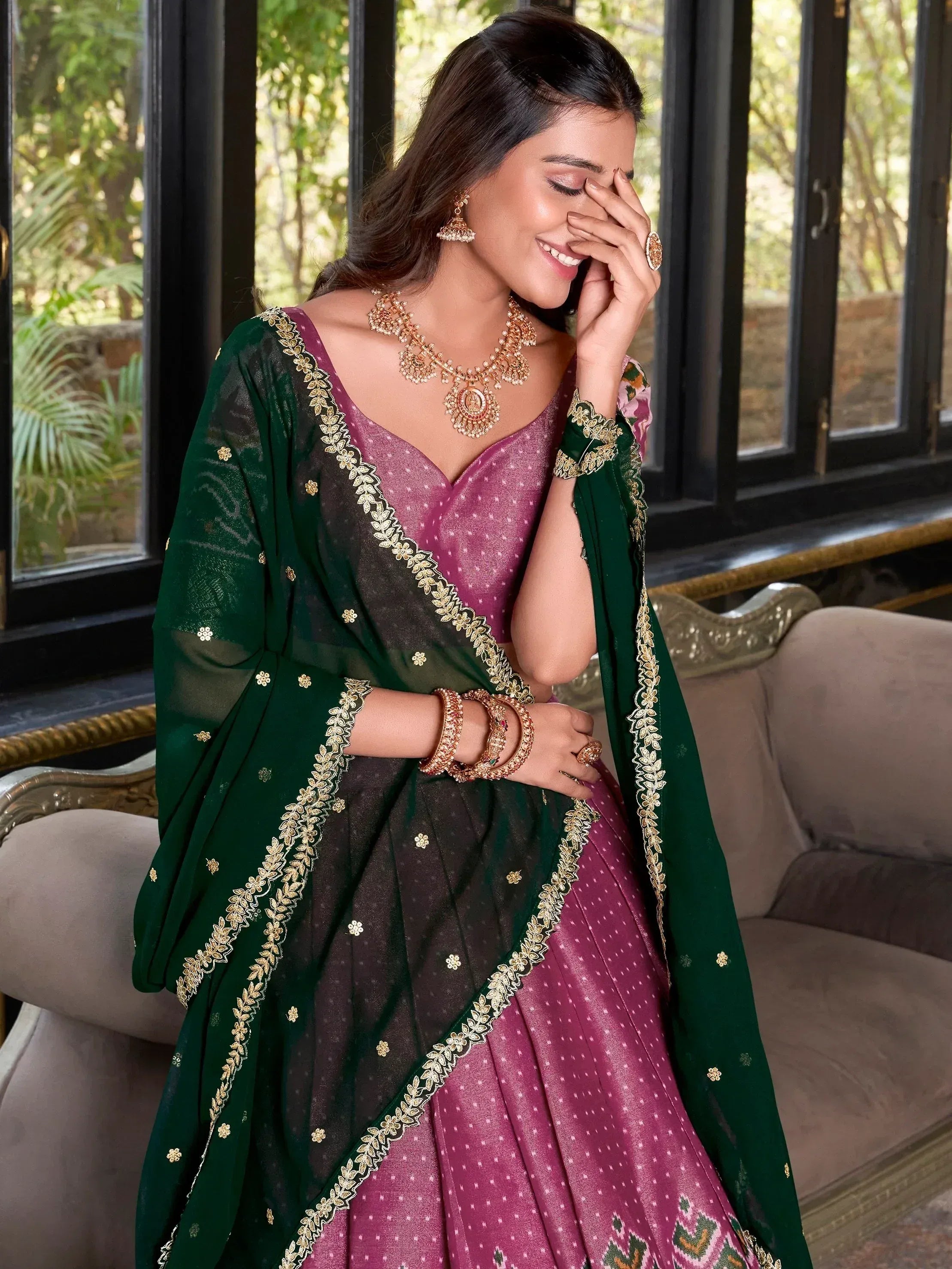Elegant purple and green designer lehenga choli with gold embroidery, perfect for Indian ethnic wear occasions.