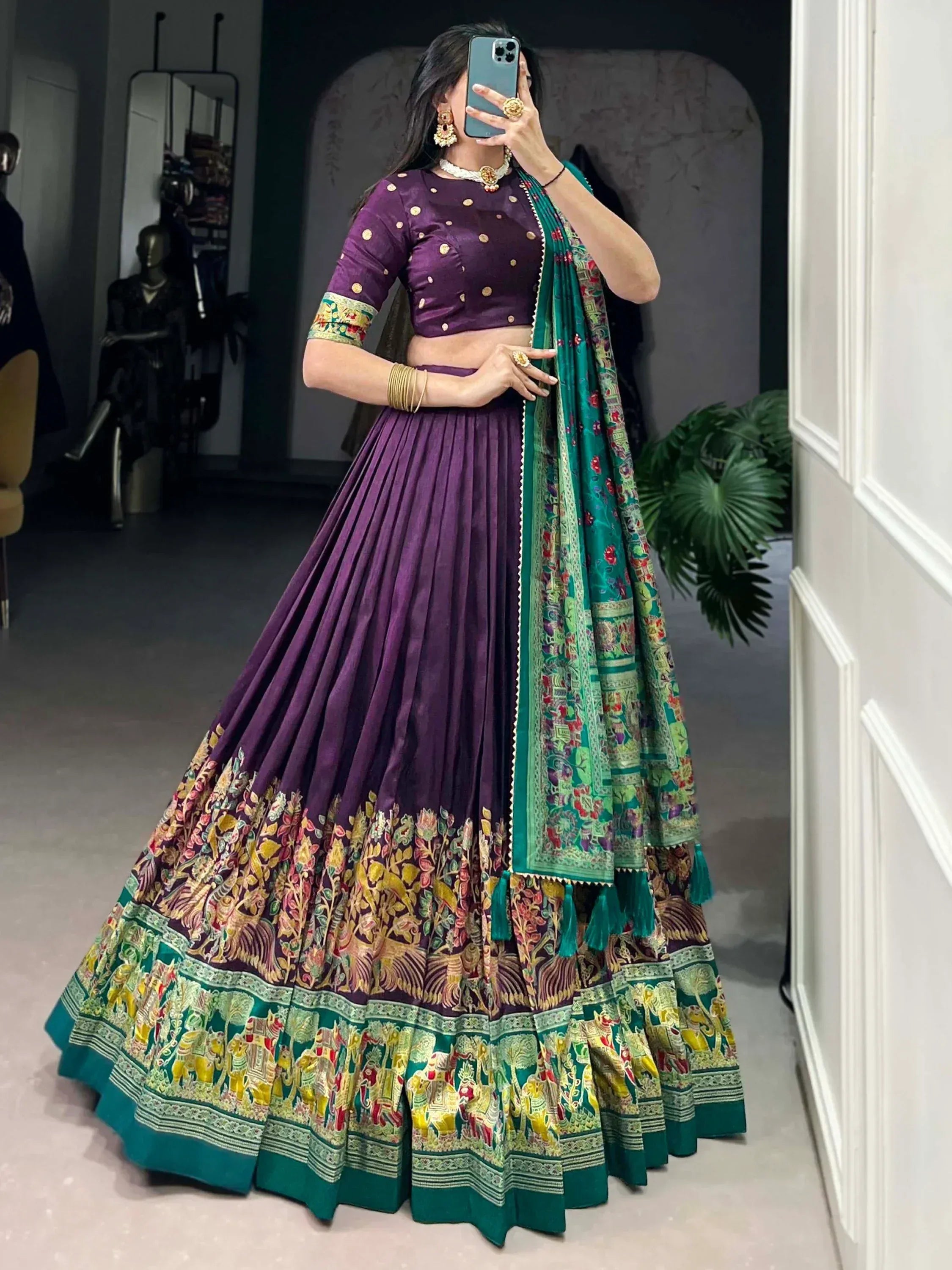 Purple and green embroidered lehenga choli with floral and elephant motifs, perfect for Indian ethnic wear