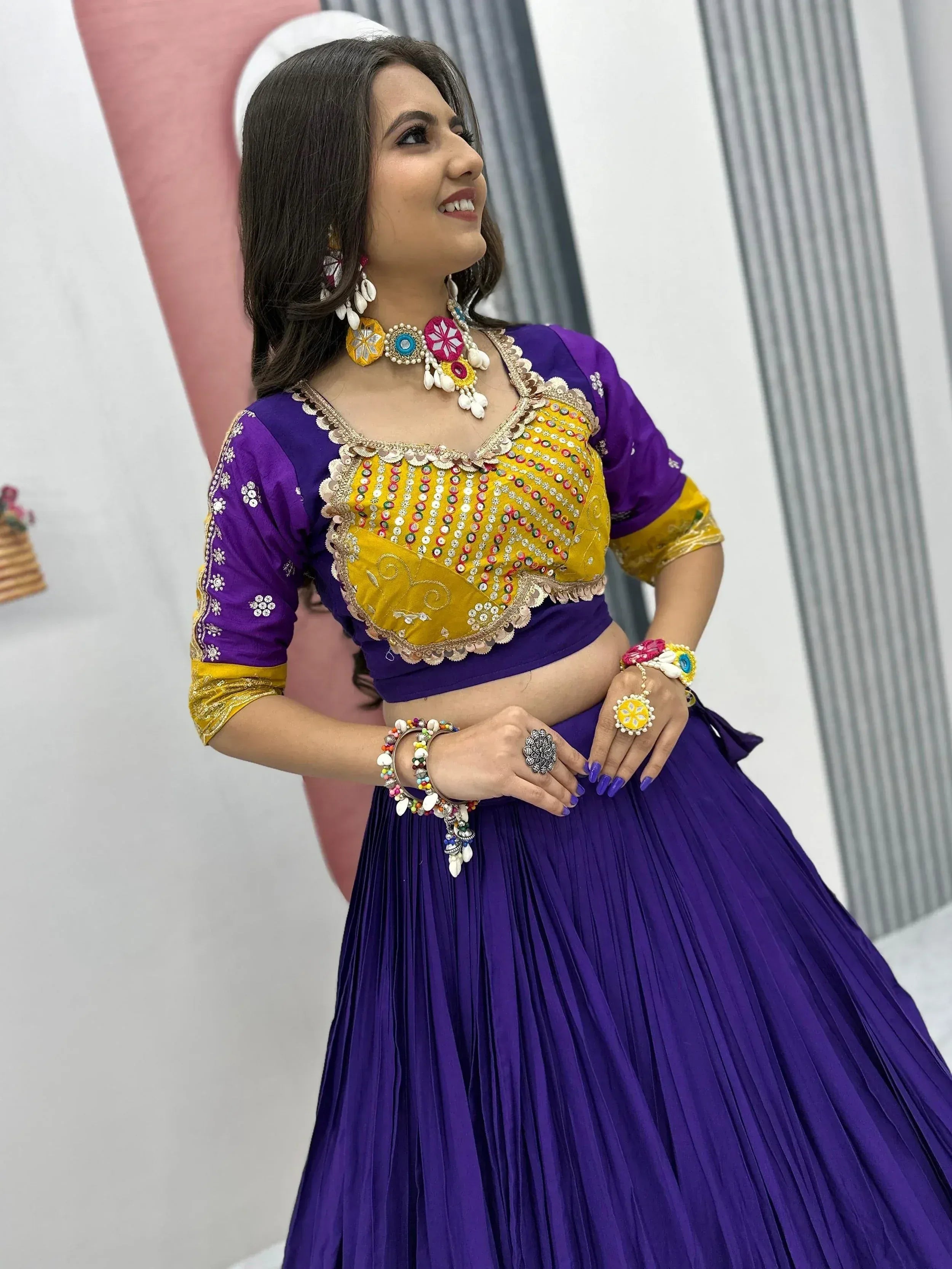 Purple and yellow designer lehenga choli with mirror work, perfect for Indian ethnic wear and festive occasions.