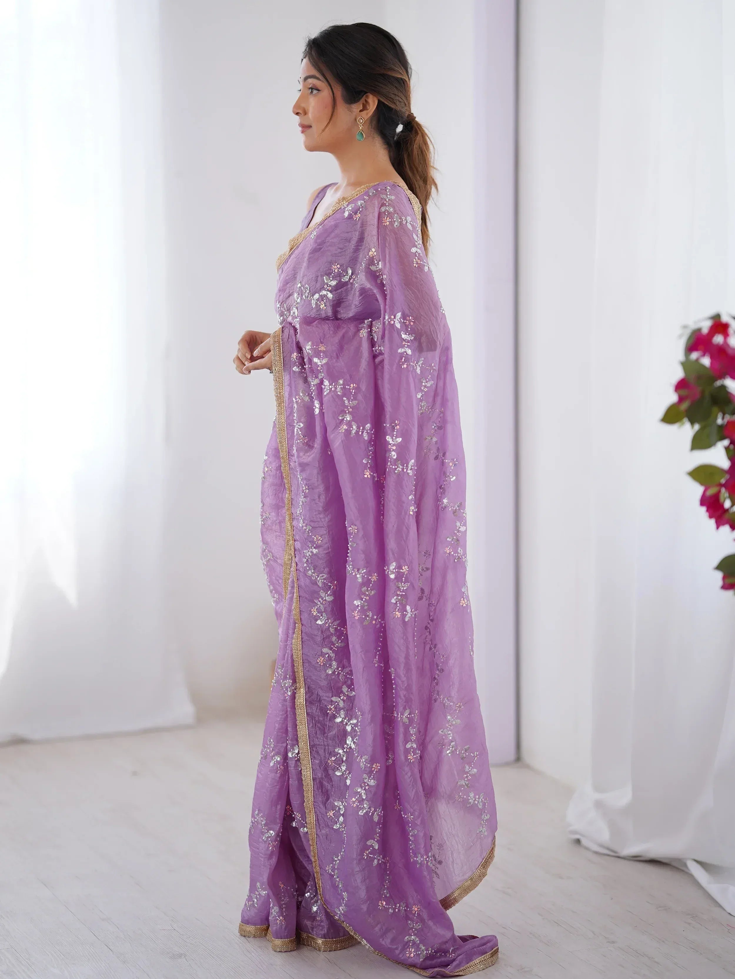 Lavender ethnic saree with gold border and sequin embroidery, perfect for Indian occasions