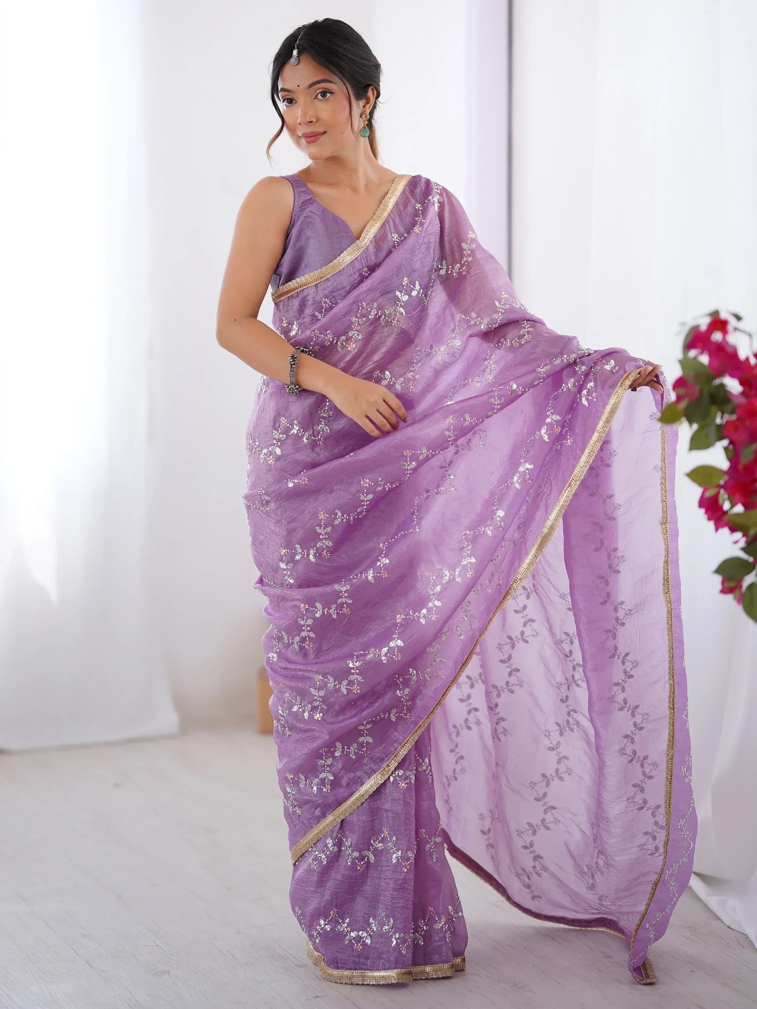 Lavender ethnic saree with silver floral embroidery and gold border, styled with traditional jewelry