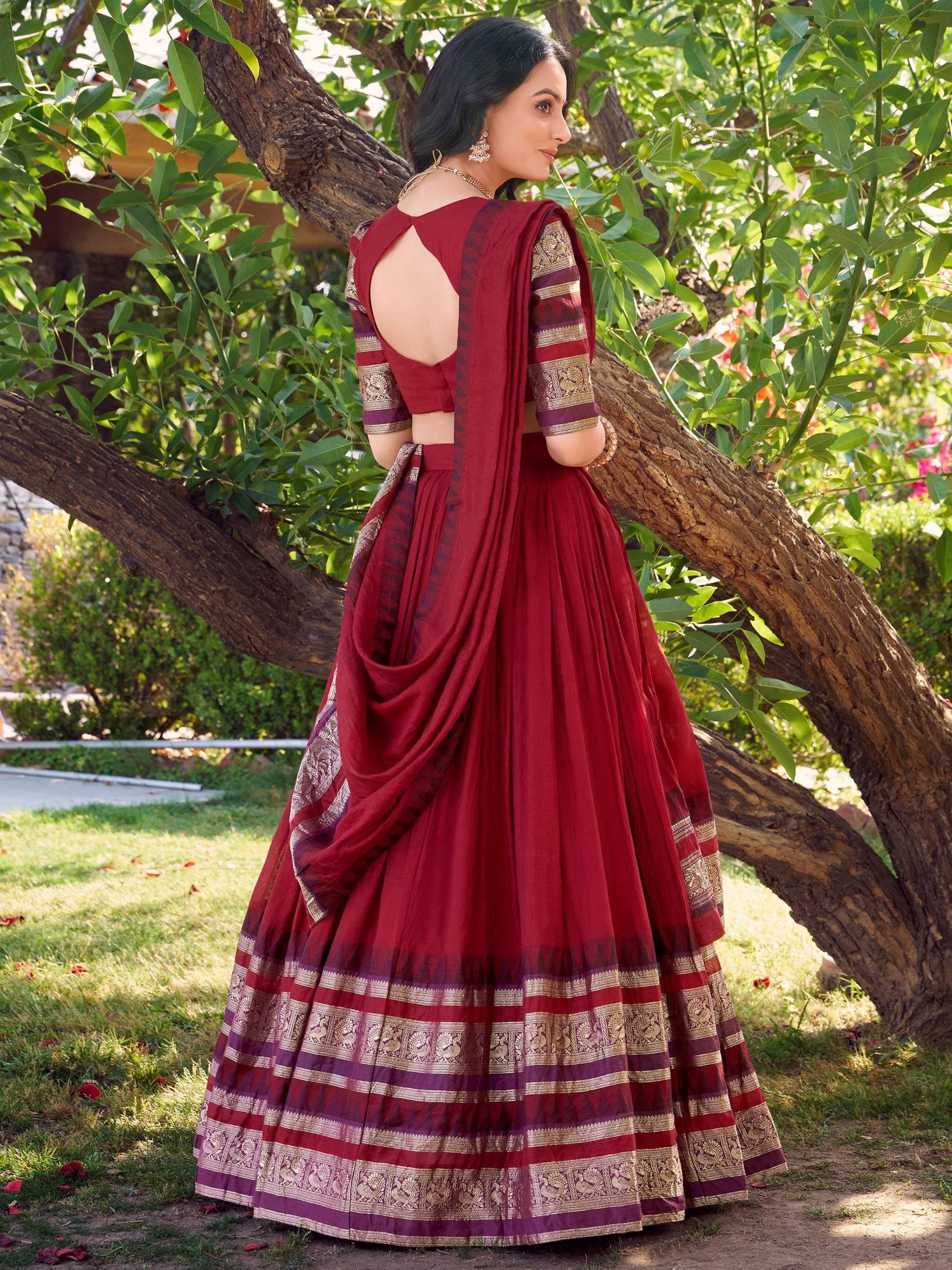 Maroon designer lehenga choli with gold embroidery, backless blouse, and pleated skirt, perfect for Indian ethnic wear.