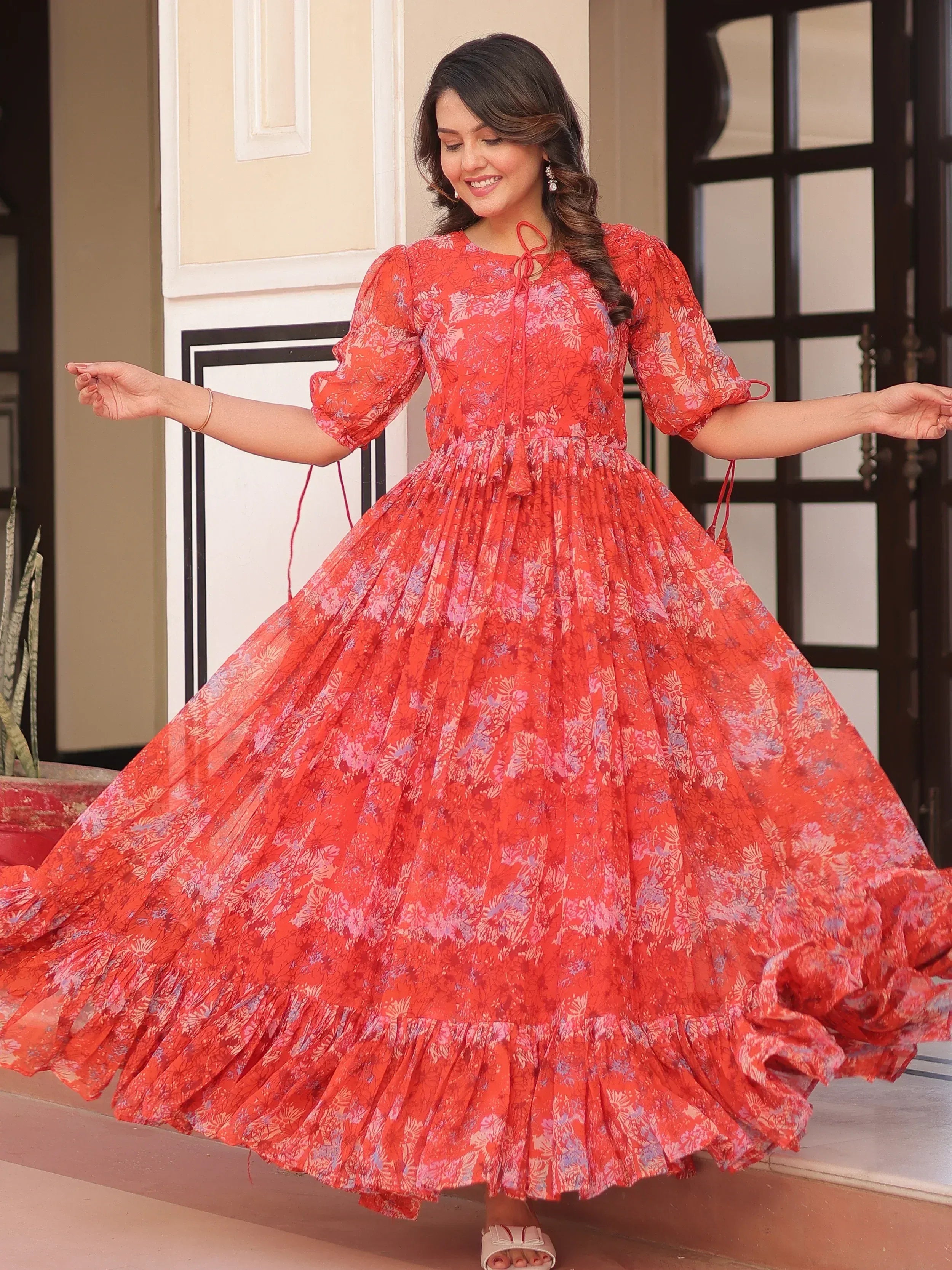 Red floral print ethnic gown with puff sleeves and flared skirt, perfect for festive occasions.