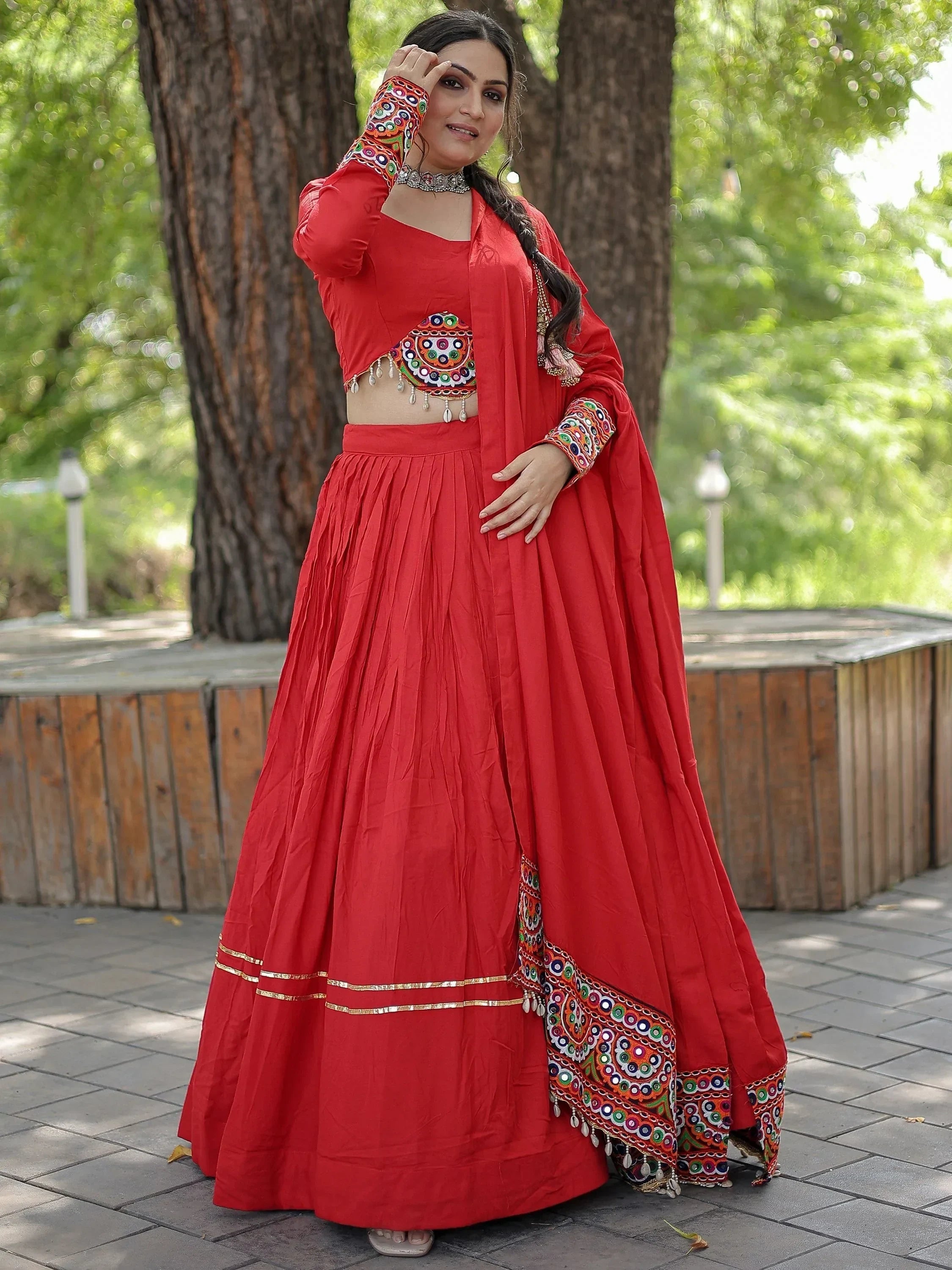 Red ethnic lehenga choli with mirror work and embroidery, perfect for Indian festivals and weddings