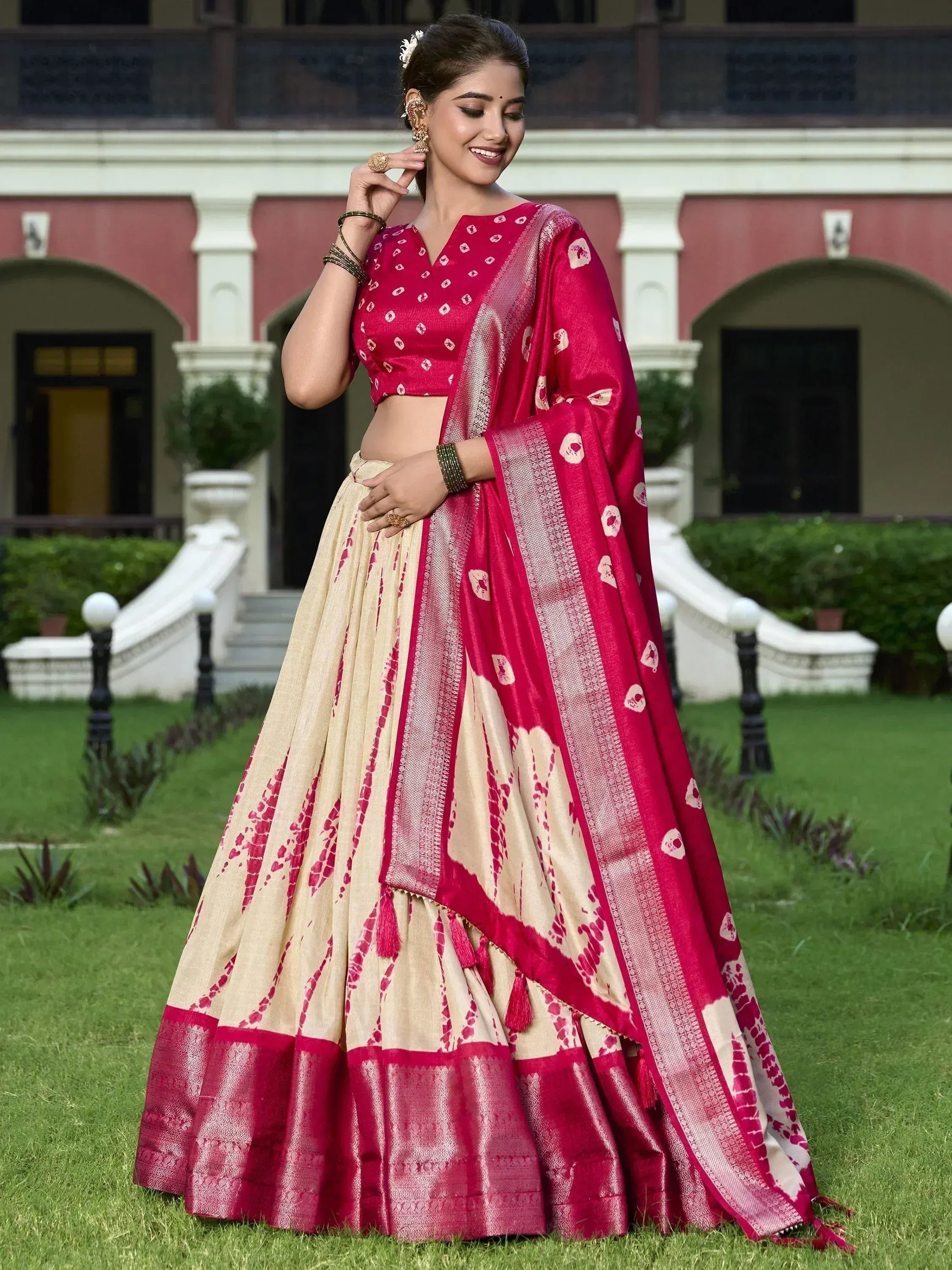 Woman in elegant pink and cream designer lehenga choli with floral print, perfect for Indian ethnic wear occasions