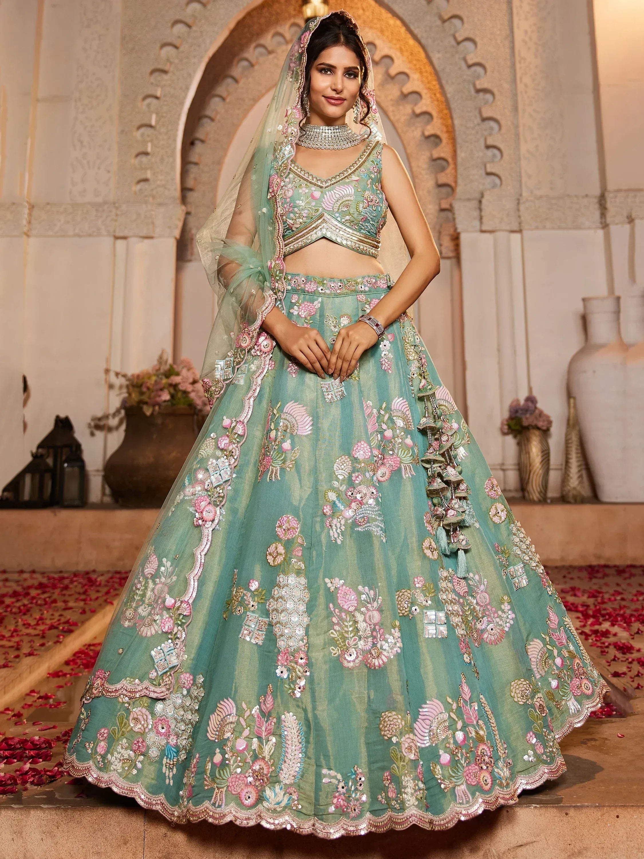 Mint green embroidered lehenga choli with floral motifs, perfect for Indian weddings and festive occasions.