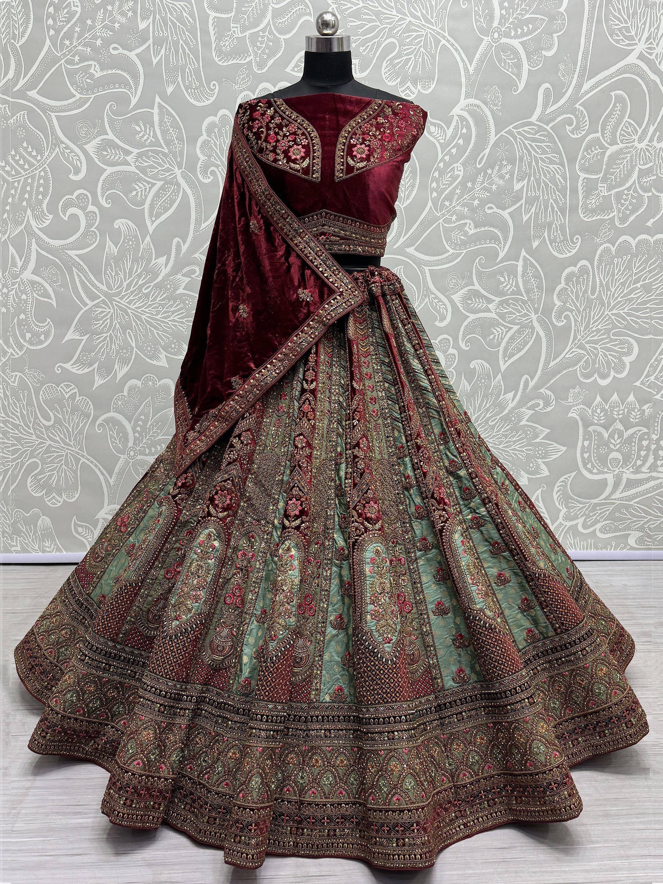 Maroon velvet designer lehenga choli with heavy embroidery and green skirt, perfect for Indian weddings