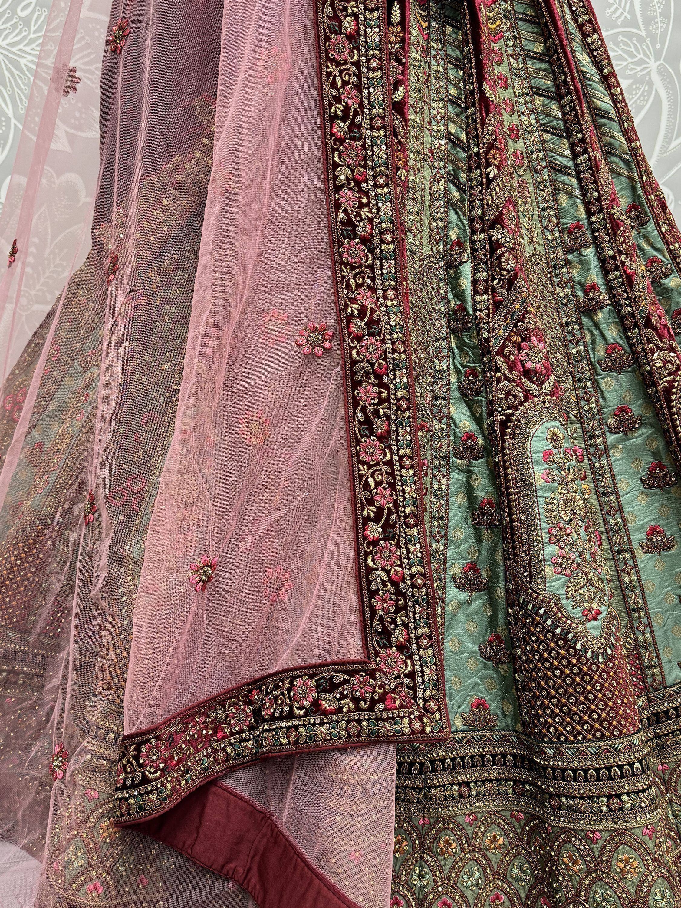Designer lehenga choli with intricate embroidery, floral motifs, and sheer dupatta for Indian ethnic wear