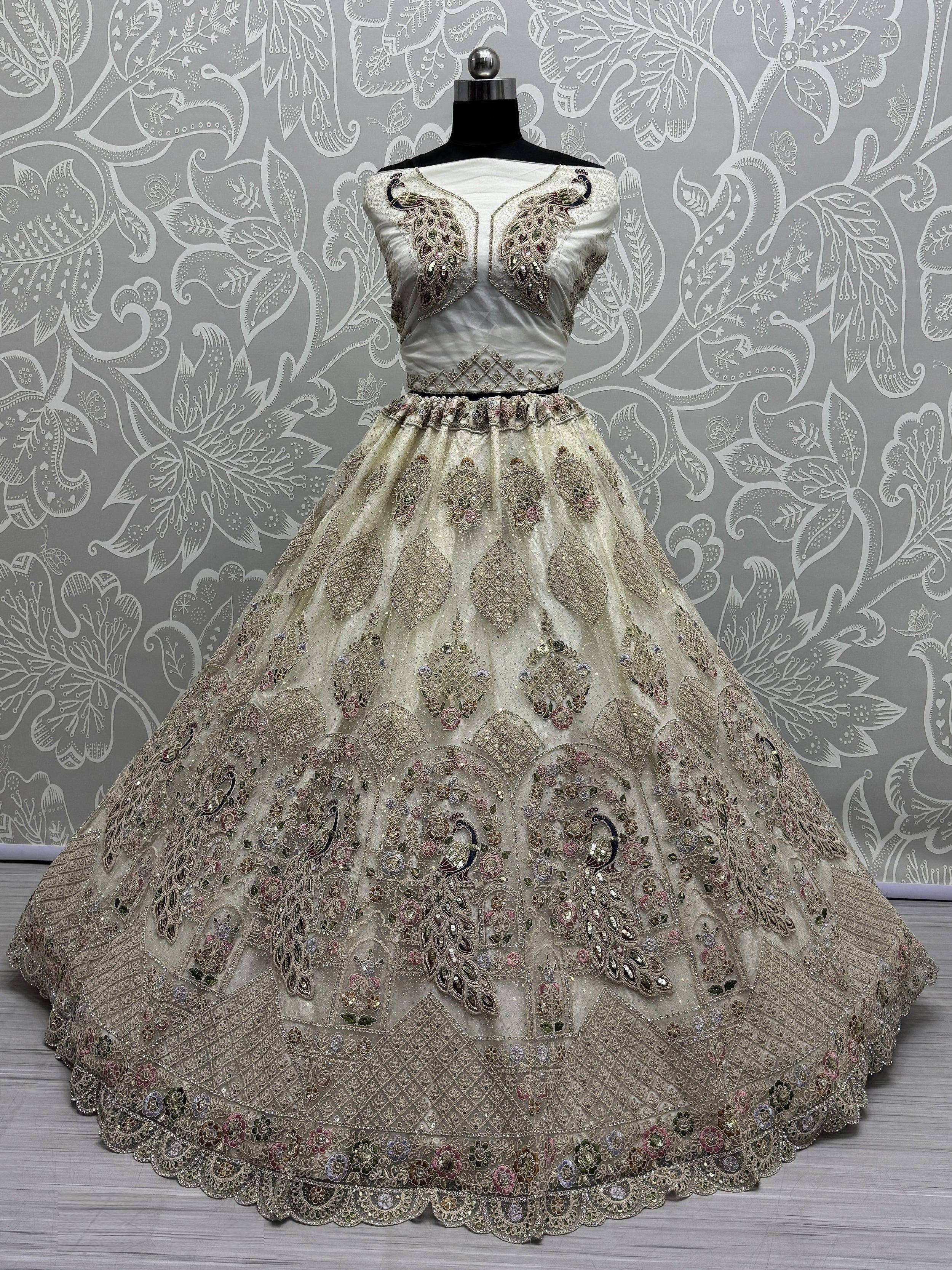 Elegant ivory lehenga choli with peacock embroidery, perfect for Indian weddings and festive occasions.