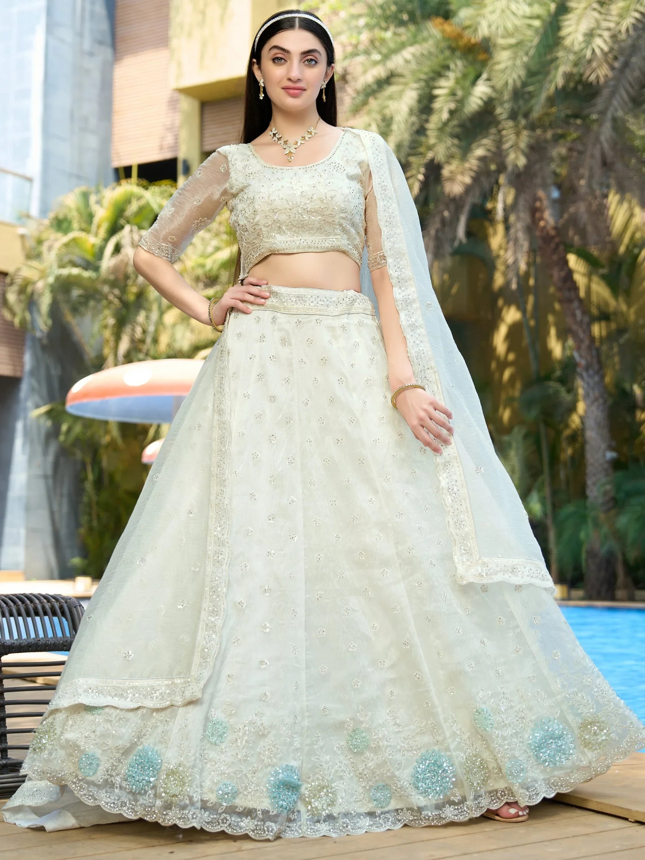 Elegant off-white lehenga choli with floral embroidery, perfect for Indian weddings and festive occasions.