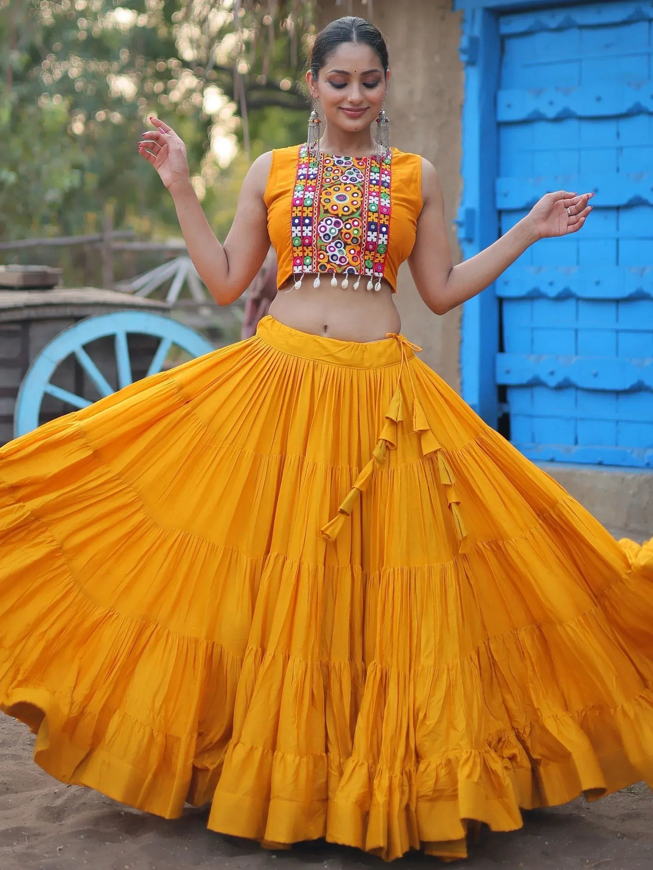 Vibrant yellow ethnic lehenga choli with colorful embroidery, perfect for festive occasions and traditional celebrations.