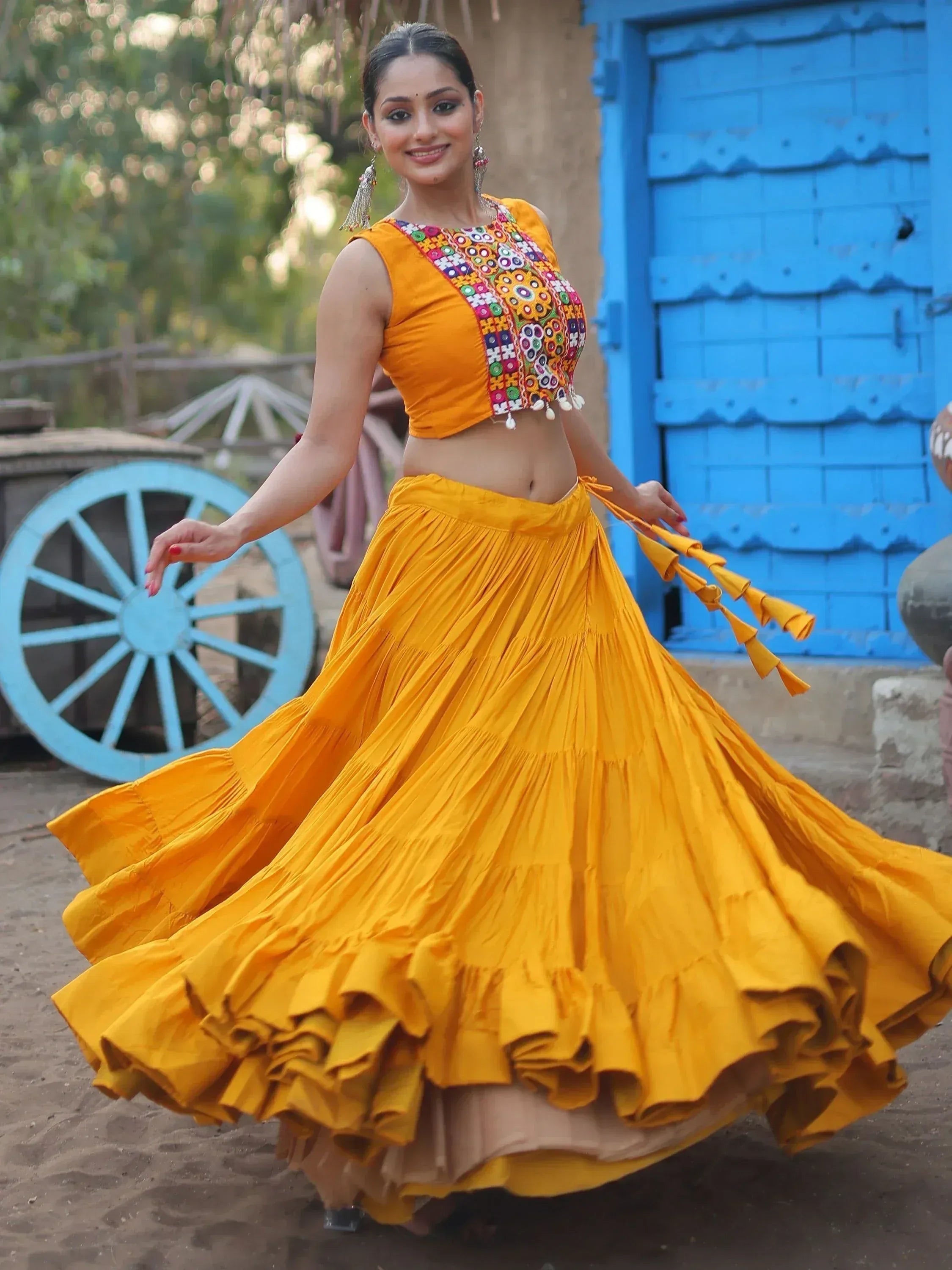 Vibrant yellow ethnic lehenga choli with colorful embroidery, perfect for festive occasions and traditional celebrations.