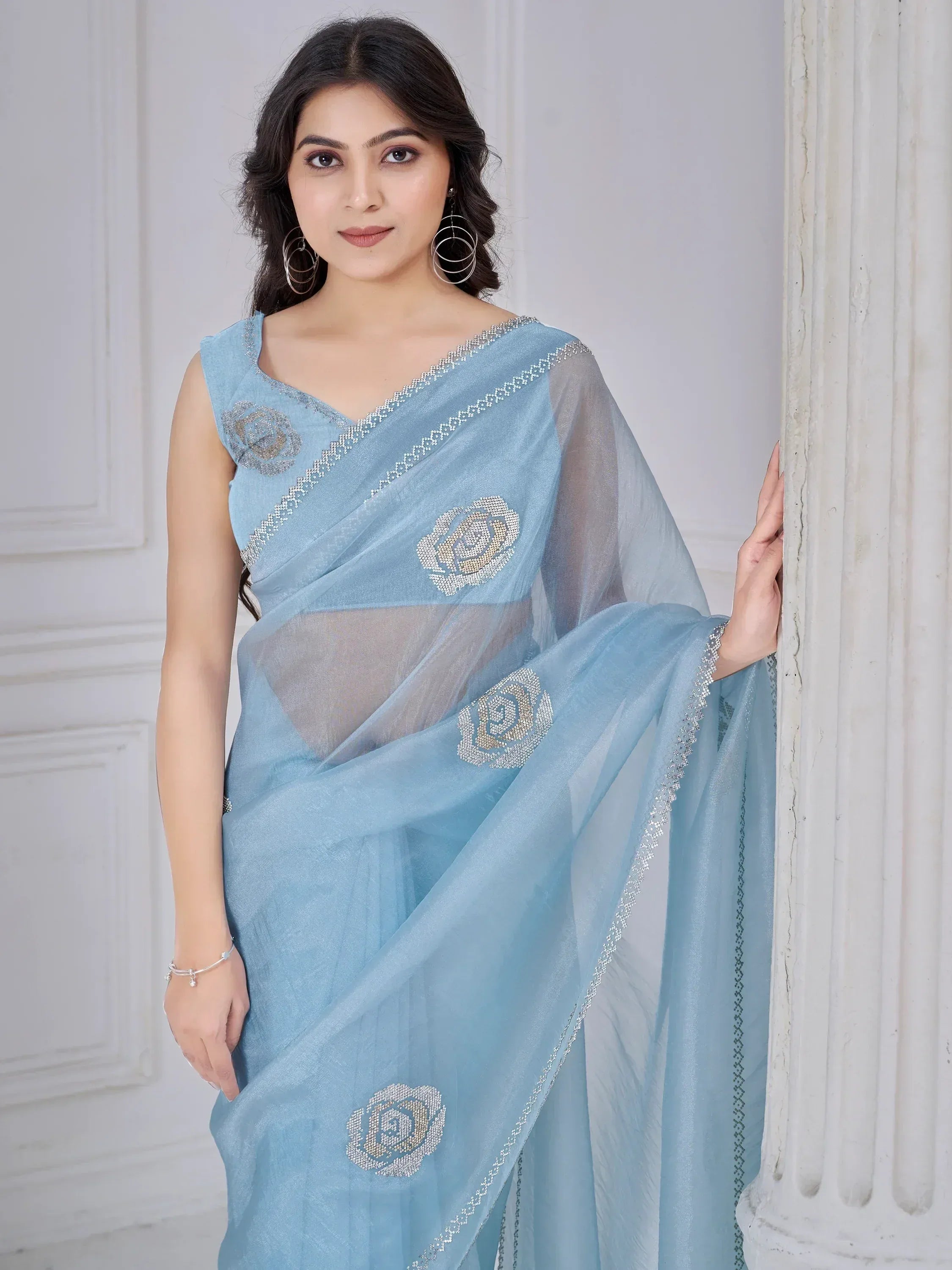 Light blue saree with floral beadwork, sheer blouse, and silver border for Indian ethnic wear