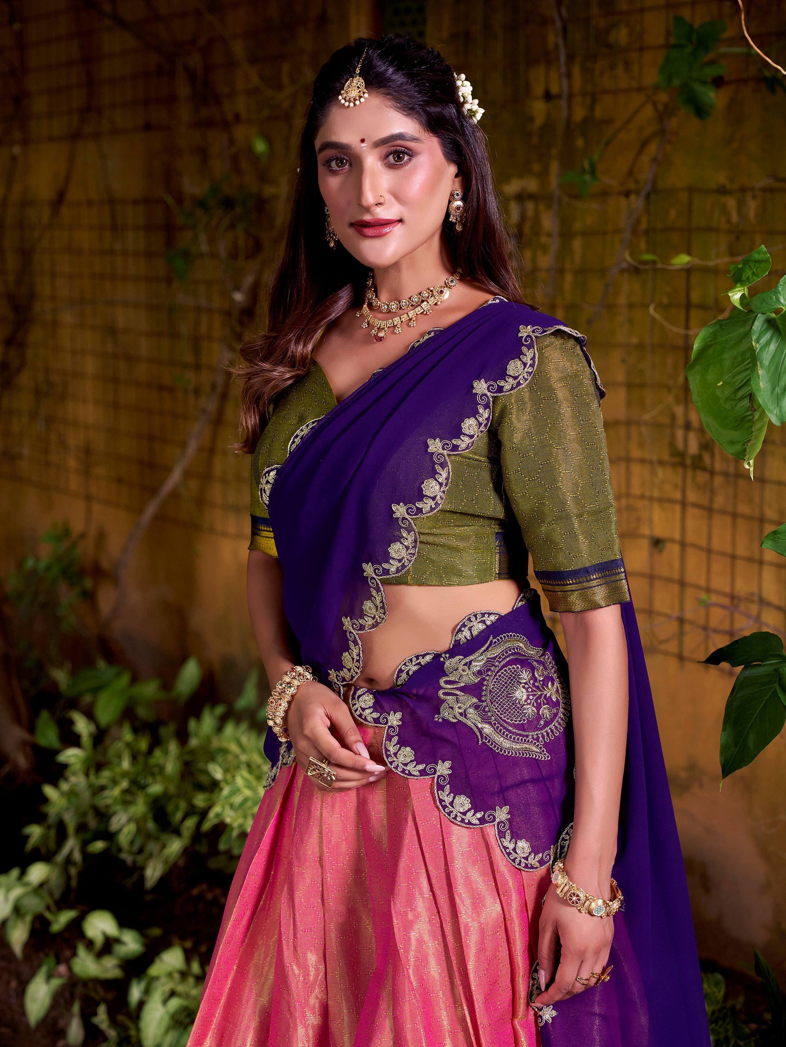 Woman in purple and pink embroidered lehenga choli with green blouse, traditional Indian ethnic wear