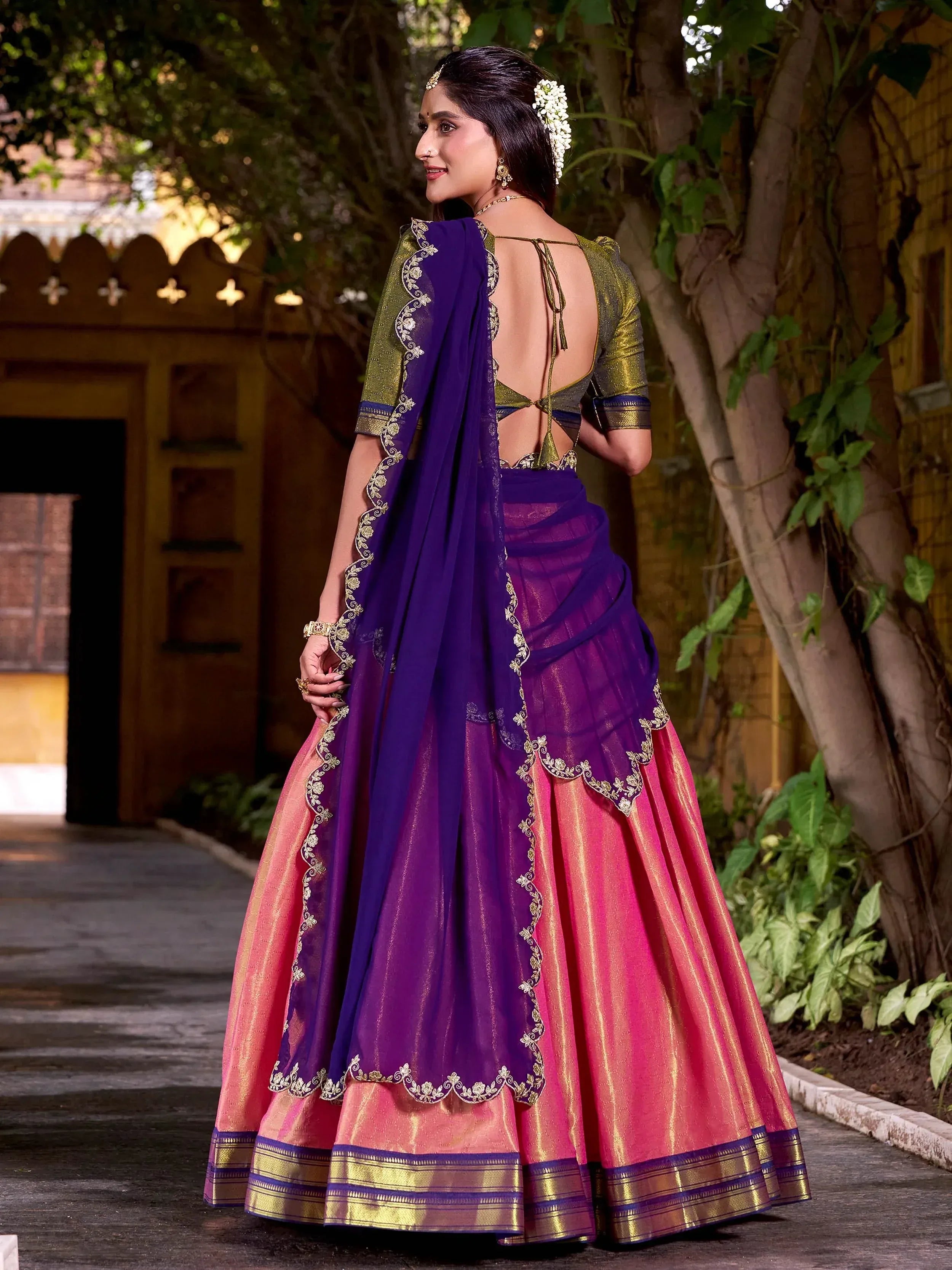 Purple and pink designer lehenga choli with gold embroidery, backless blouse, and floral dupatta for Indian ethnic wear