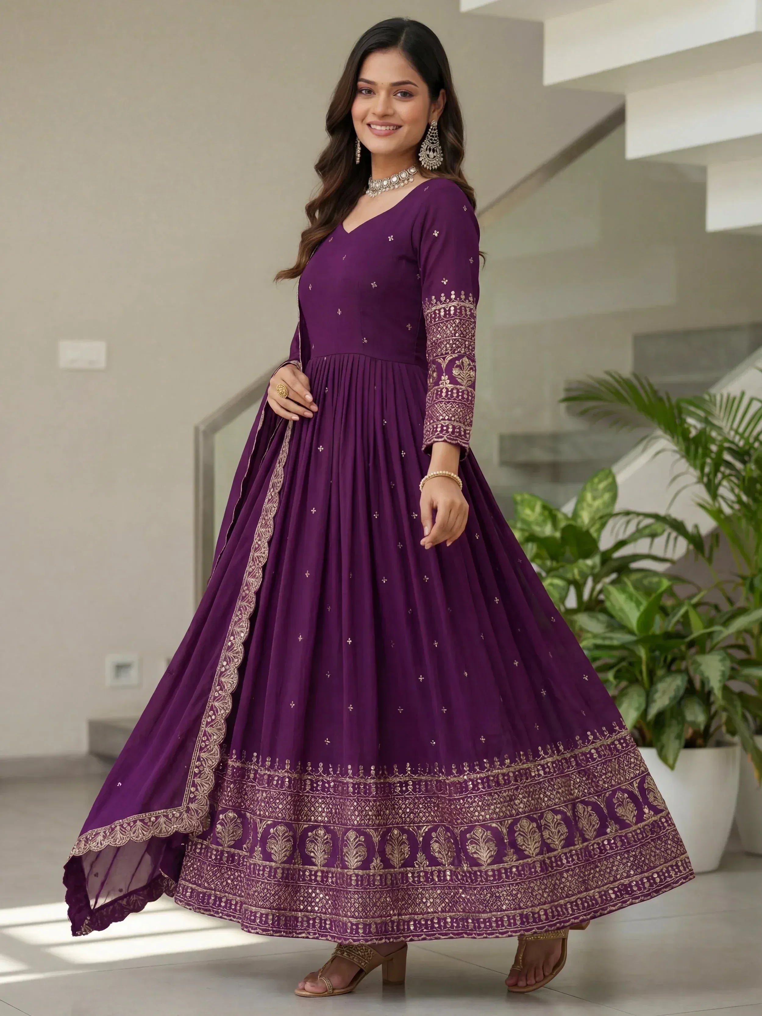 Purple ethnic gown with gold embroidery, perfect for Indian celebrations and festive occasions.