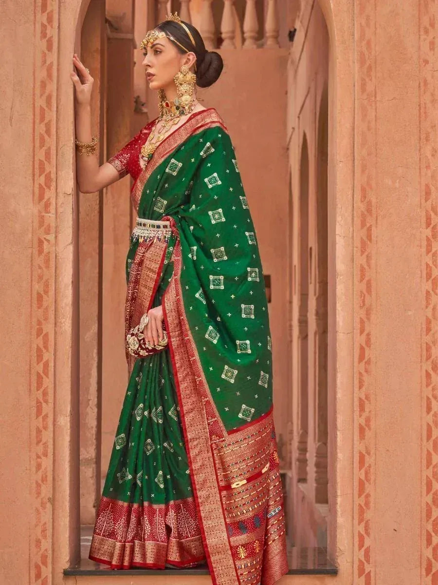 Woman in green and red ethnic saree with gold jewelry, traditional Indian attire for festive occasions
