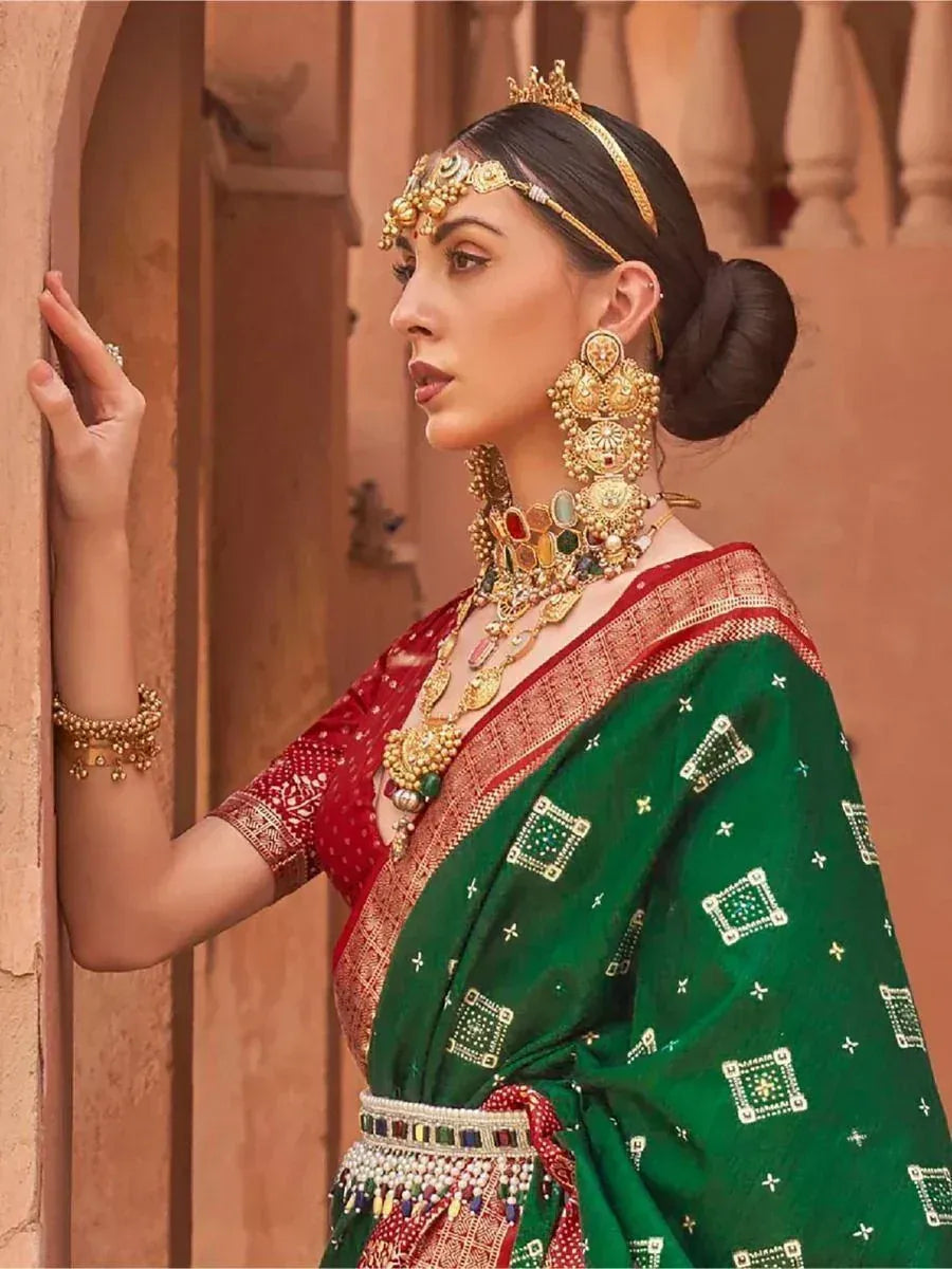 Woman in green and red ethnic saree with gold jewelry, traditional Indian attire
