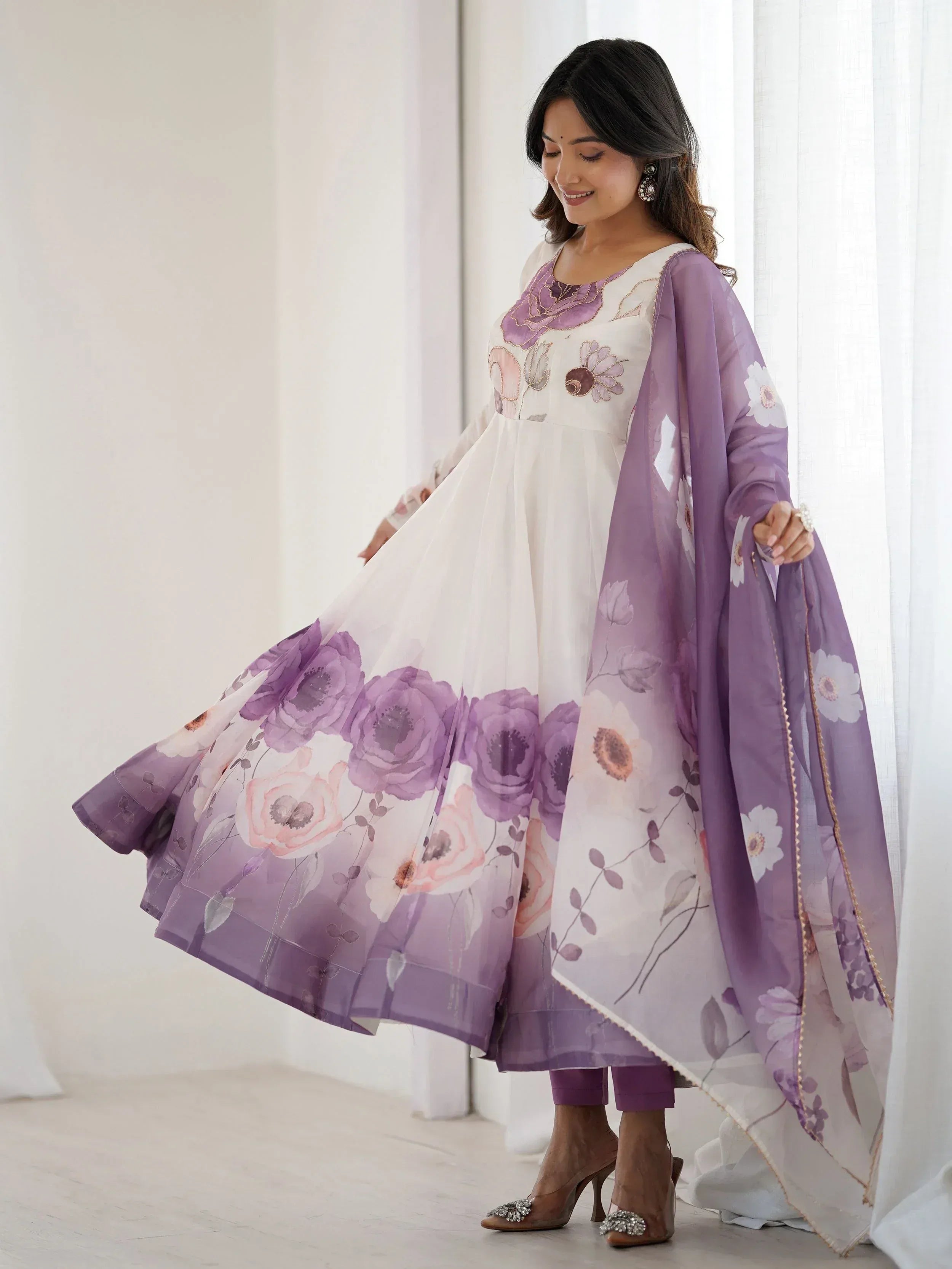 Woman in white and purple floral anarkali suit with matching dupatta, ethnic Indian wear