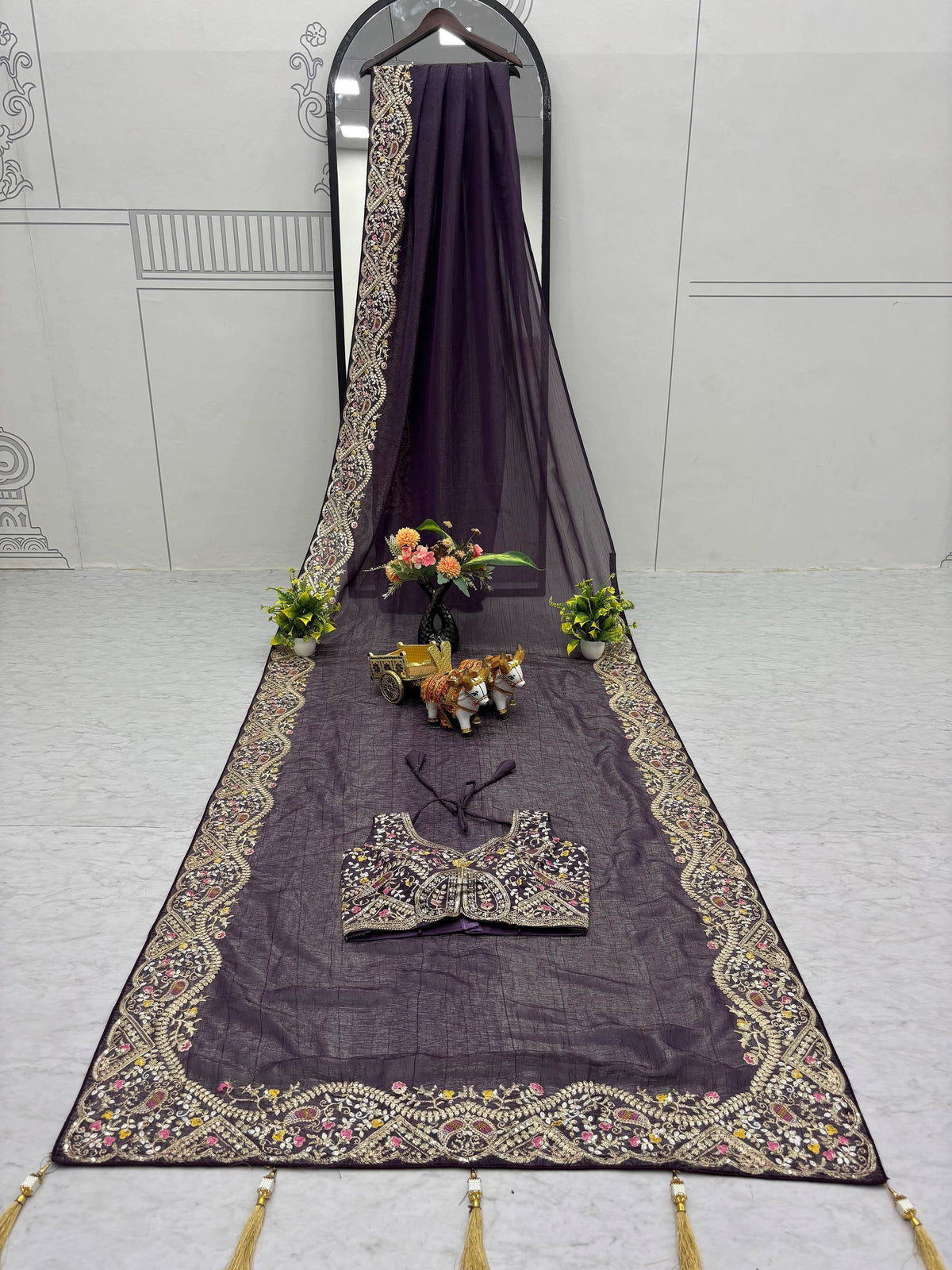 Elegant purple ethnic saree with intricate gold embroidery and matching blouse, perfect for festive occasions.