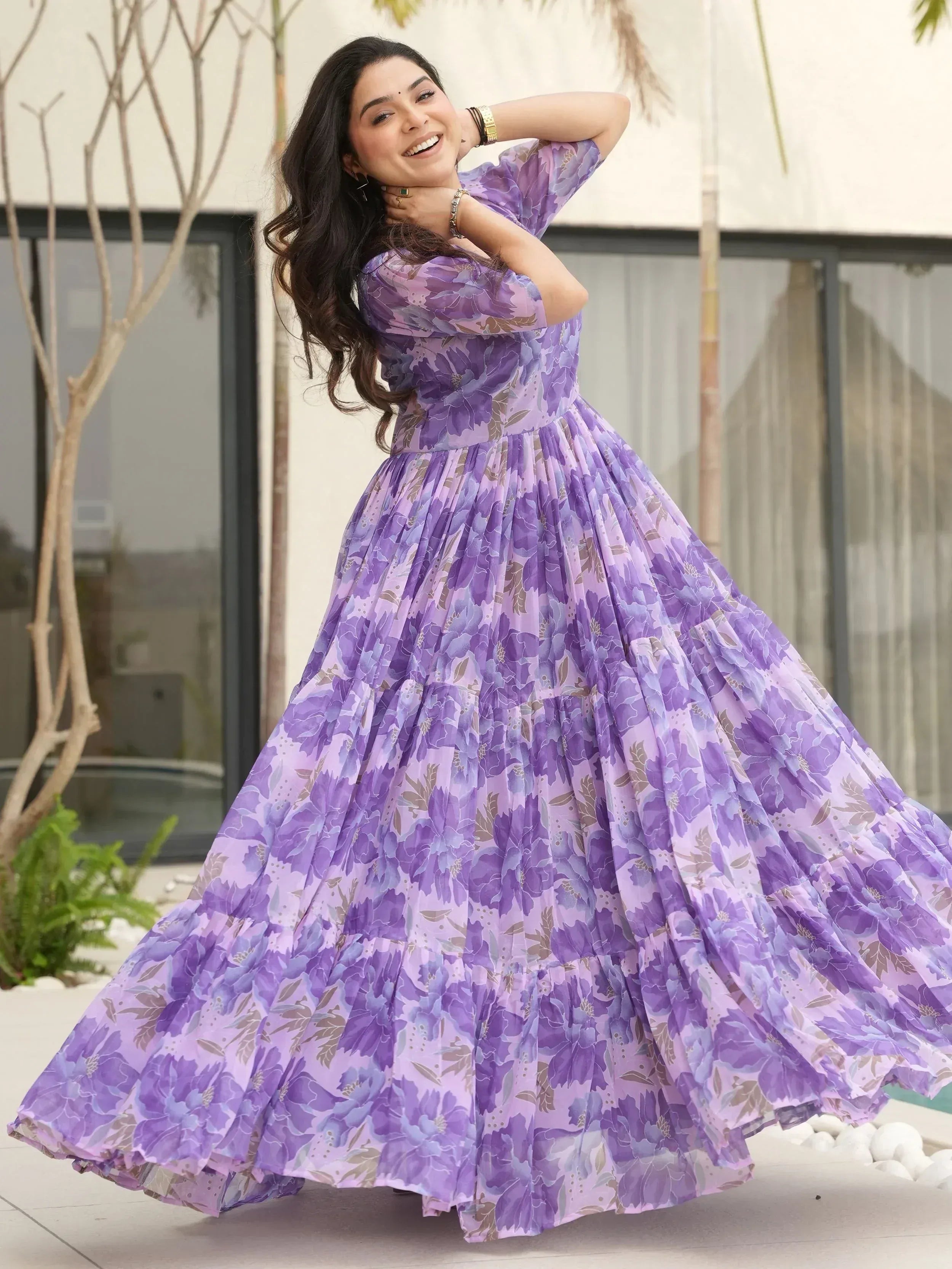 Purple floral ethnic gown with flowing skirt, perfect for festive occasions and celebrations.