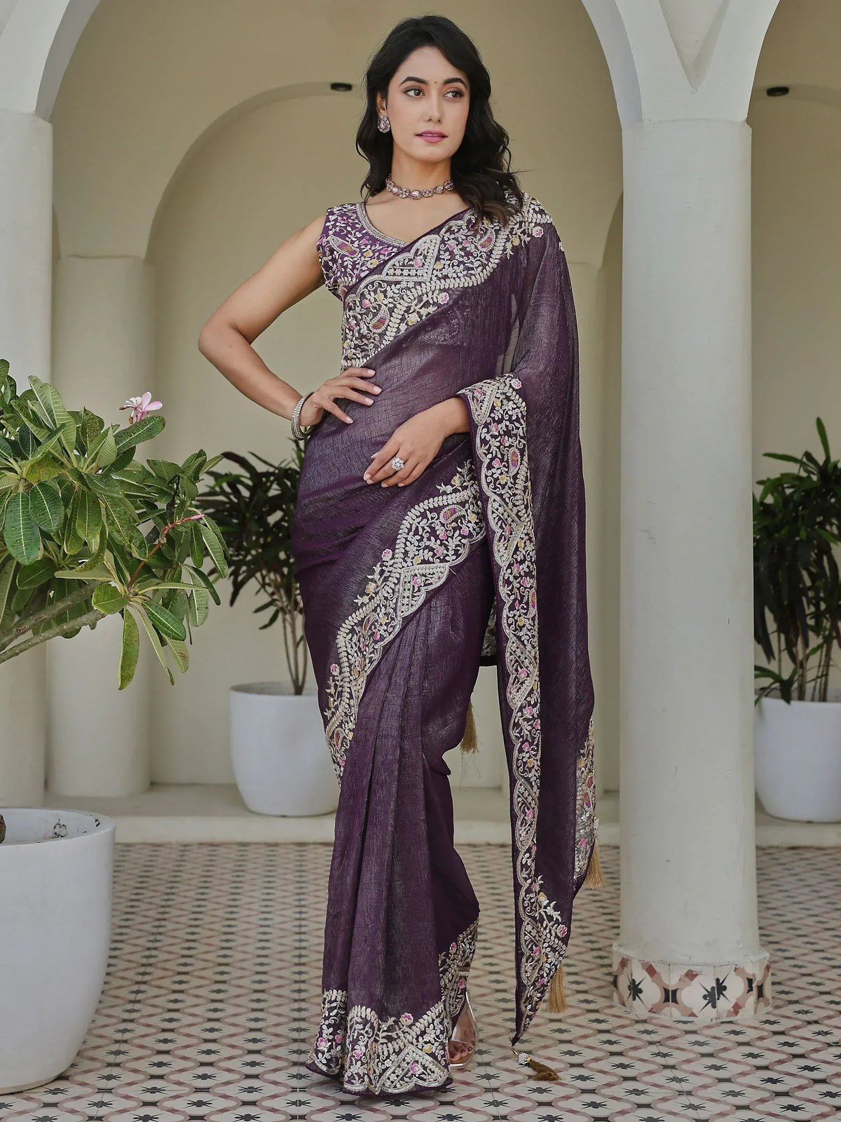 Elegant purple saree with intricate floral embroidery and tassels, perfect for Indian ethnic wear.