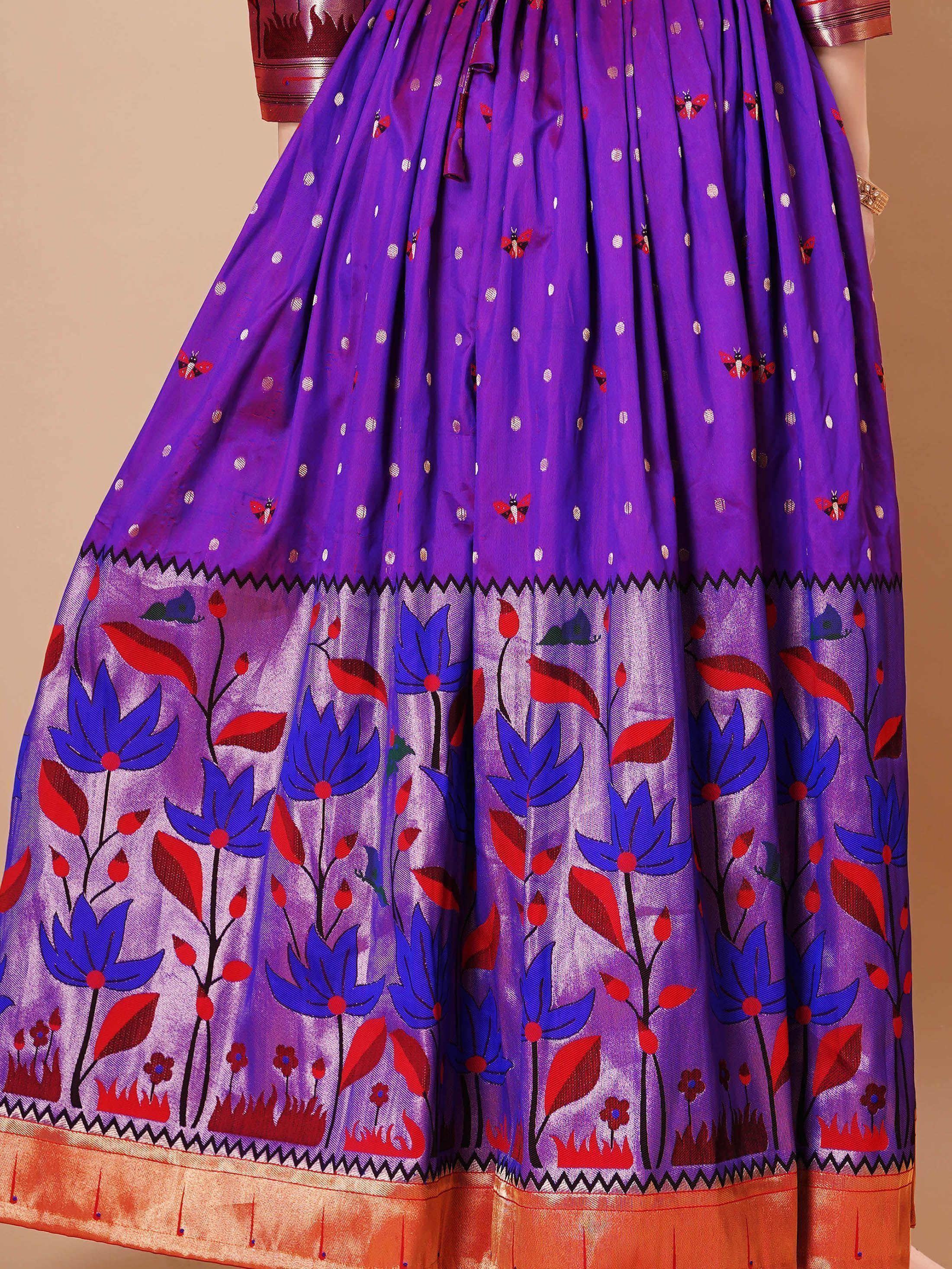 Purple ethnic skirt with floral and polka dot patterns, orange and red border, traditional Indian wear