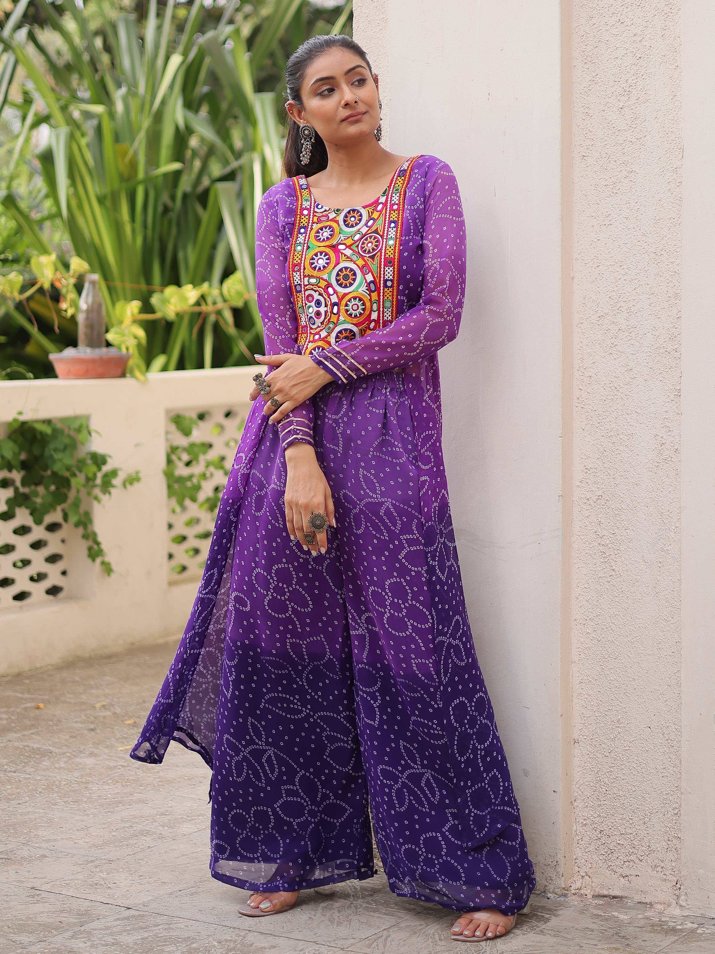 Purple ethnic gown with colorful embroidery and geometric patterns, perfect for Indian festive wear.