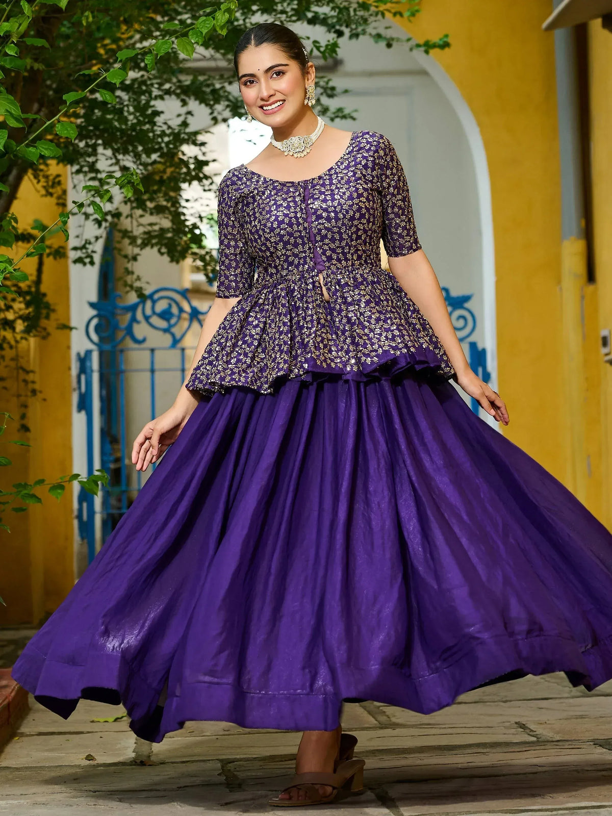 Purple floral embroidered ethnic gown with flared skirt, perfect for Indian occasions and festive wear.