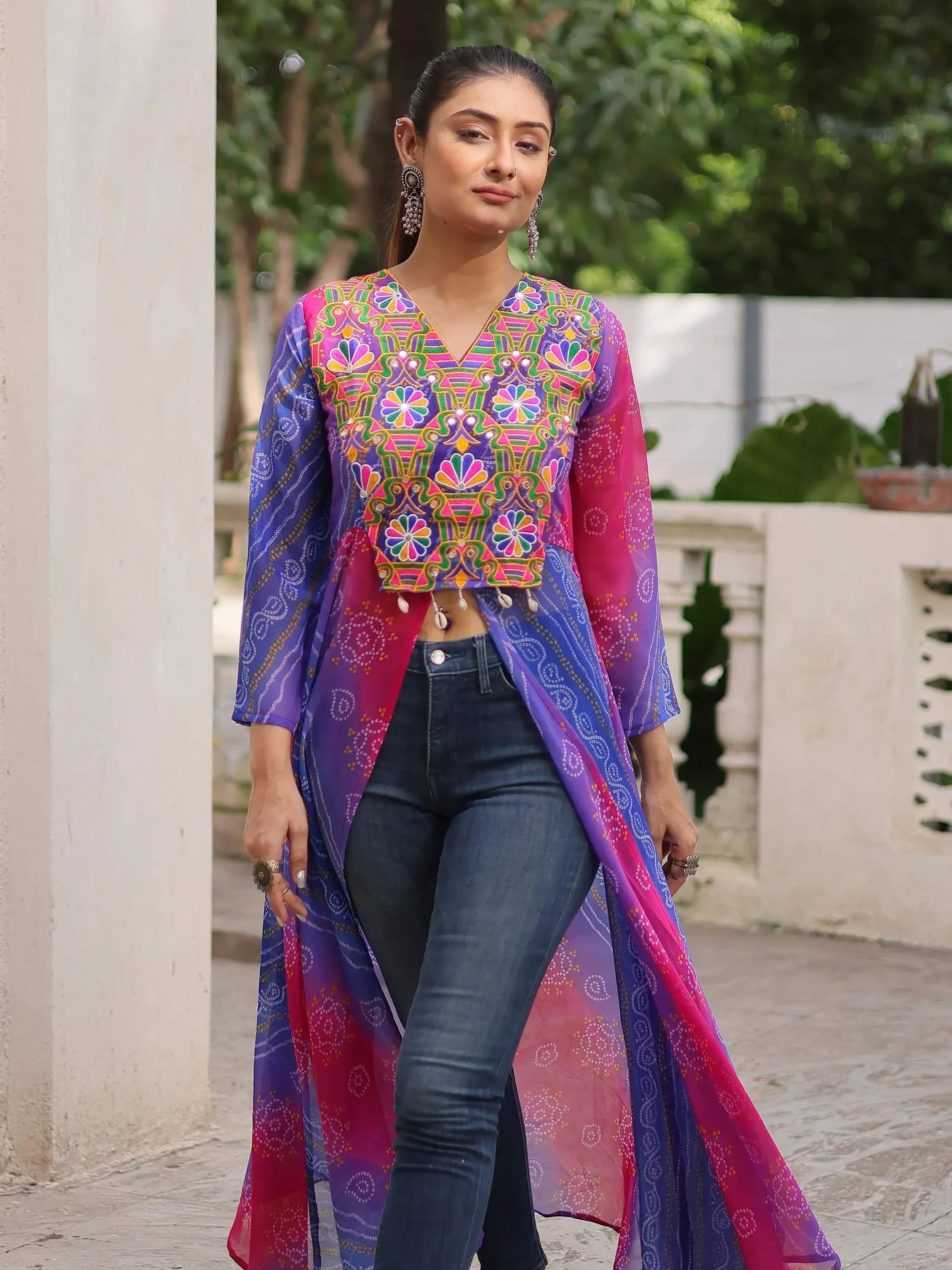 Vibrant embroidered ethnic crop top with colorful dupatta, paired with jeans for modern Indian fusion wear