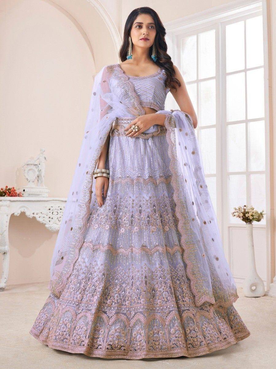 Lavender designer lehenga choli with gold embroidery and sheer dupatta, perfect for Indian weddings and festive occasions.