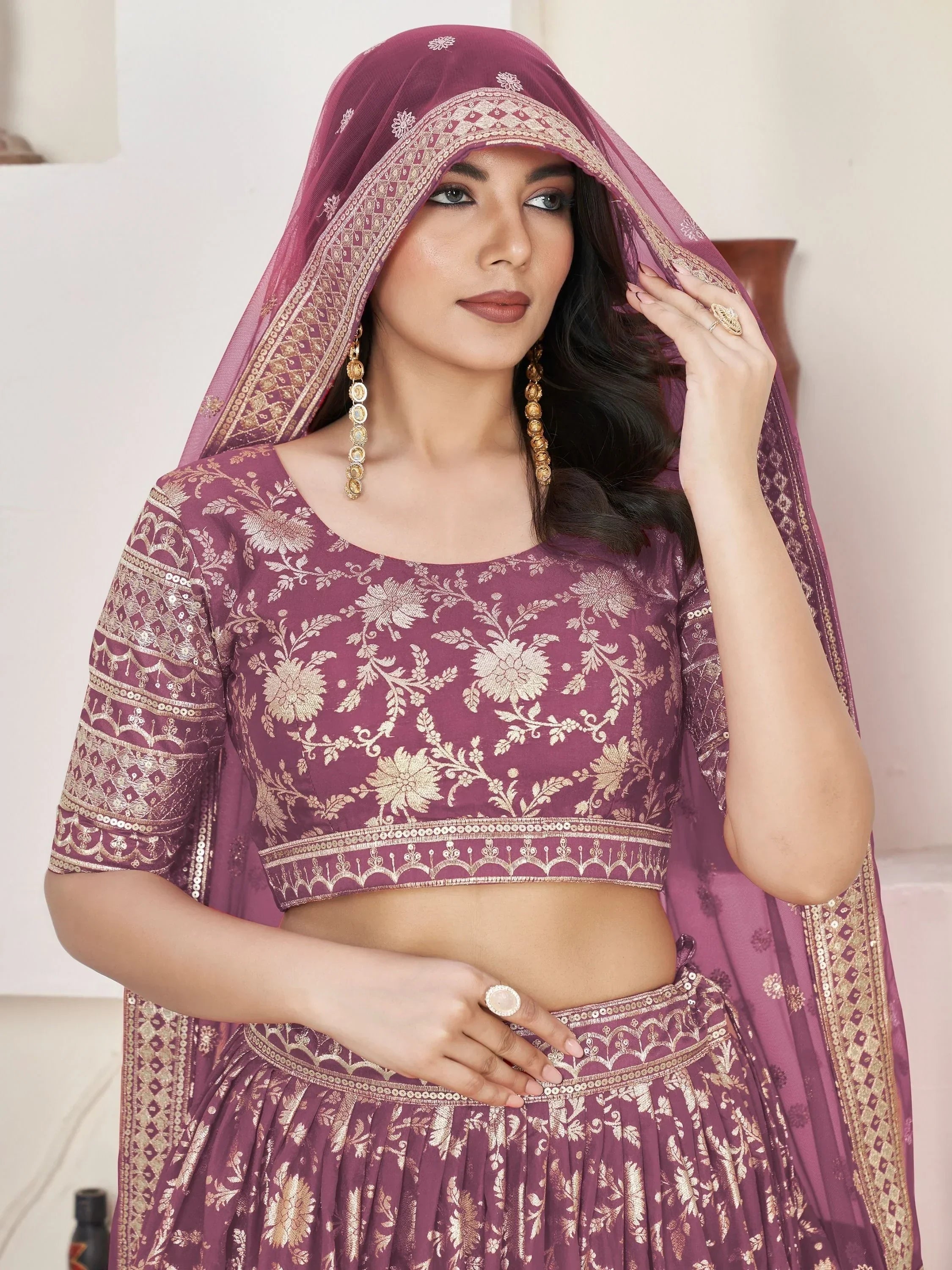 Elegant maroon lehenga choli with gold floral embroidery and matching dupatta, perfect for Indian ethnic occasions.