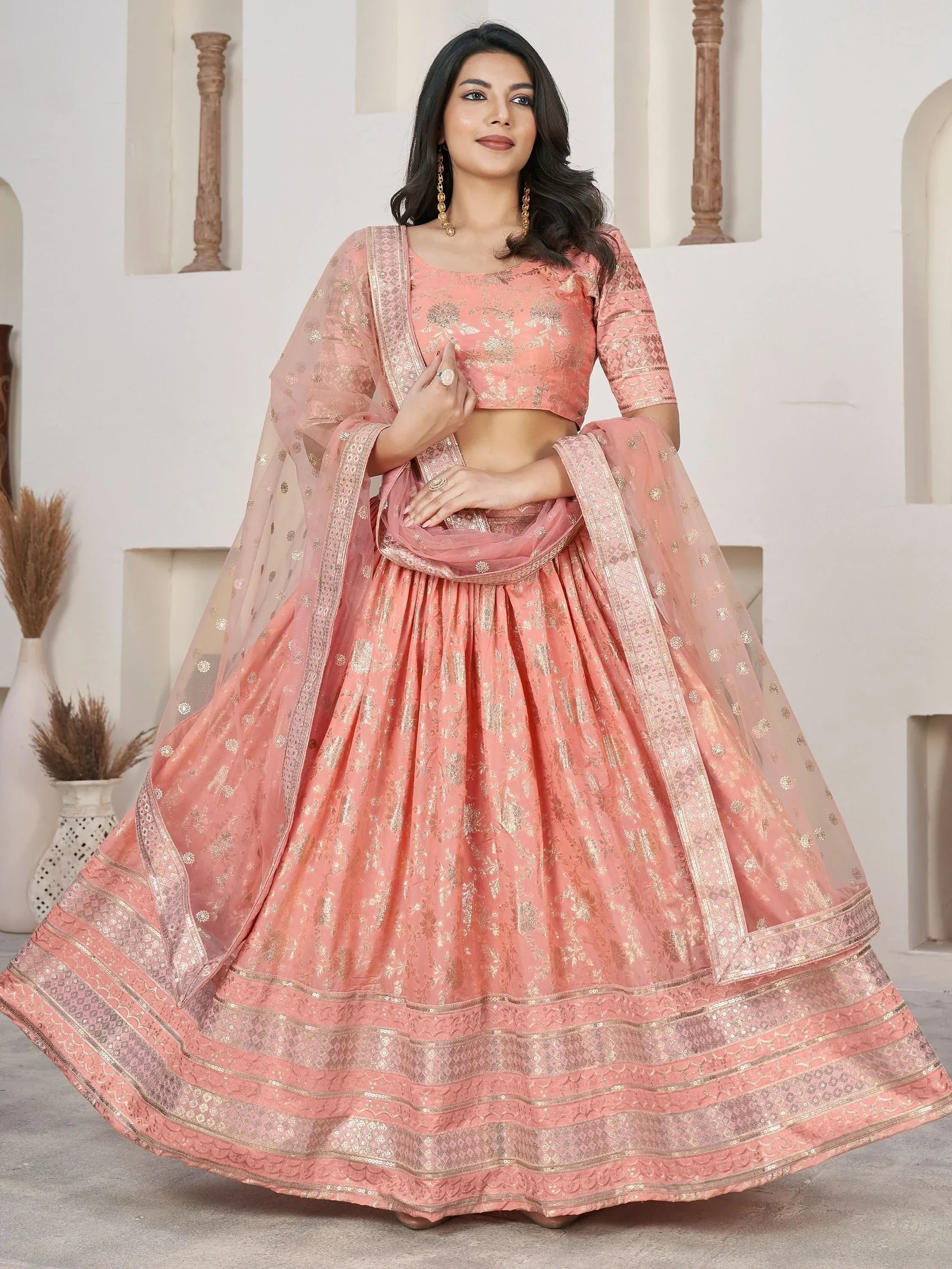 Pink floral embroidered lehenga choli with gold detailing, perfect for Indian weddings and festive occasions