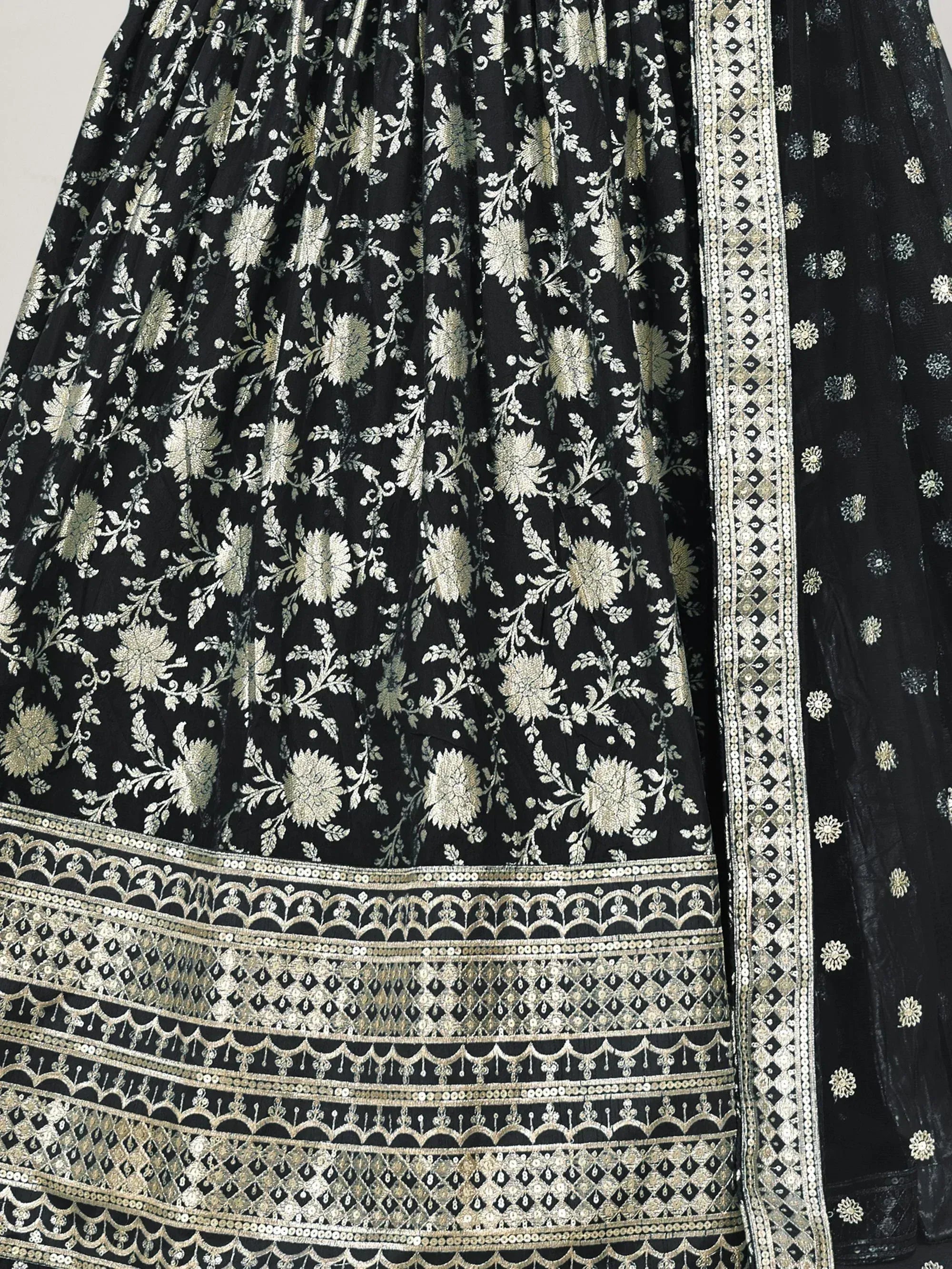 Black floral embroidered lehenga with gold zari work and detailed border, perfect for Indian ethnic wear.