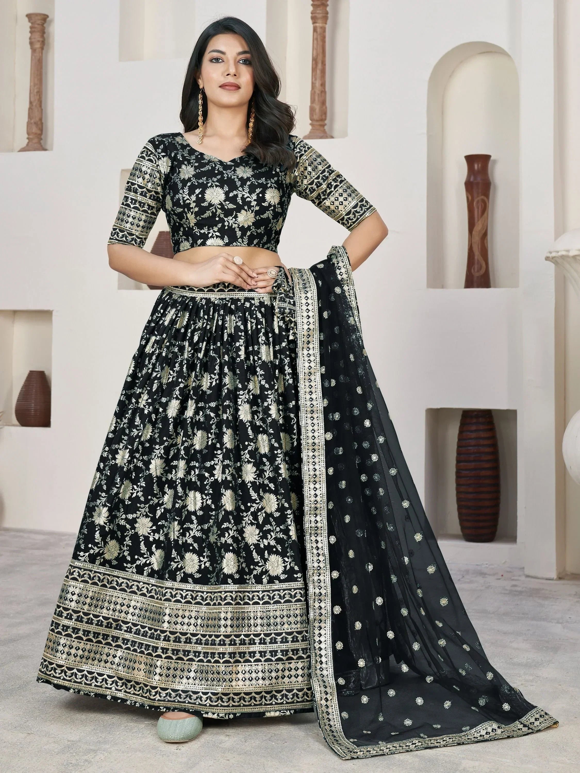 Black and gold embroidered lehenga choli with floral design, perfect for Indian ethnic wear occasions.