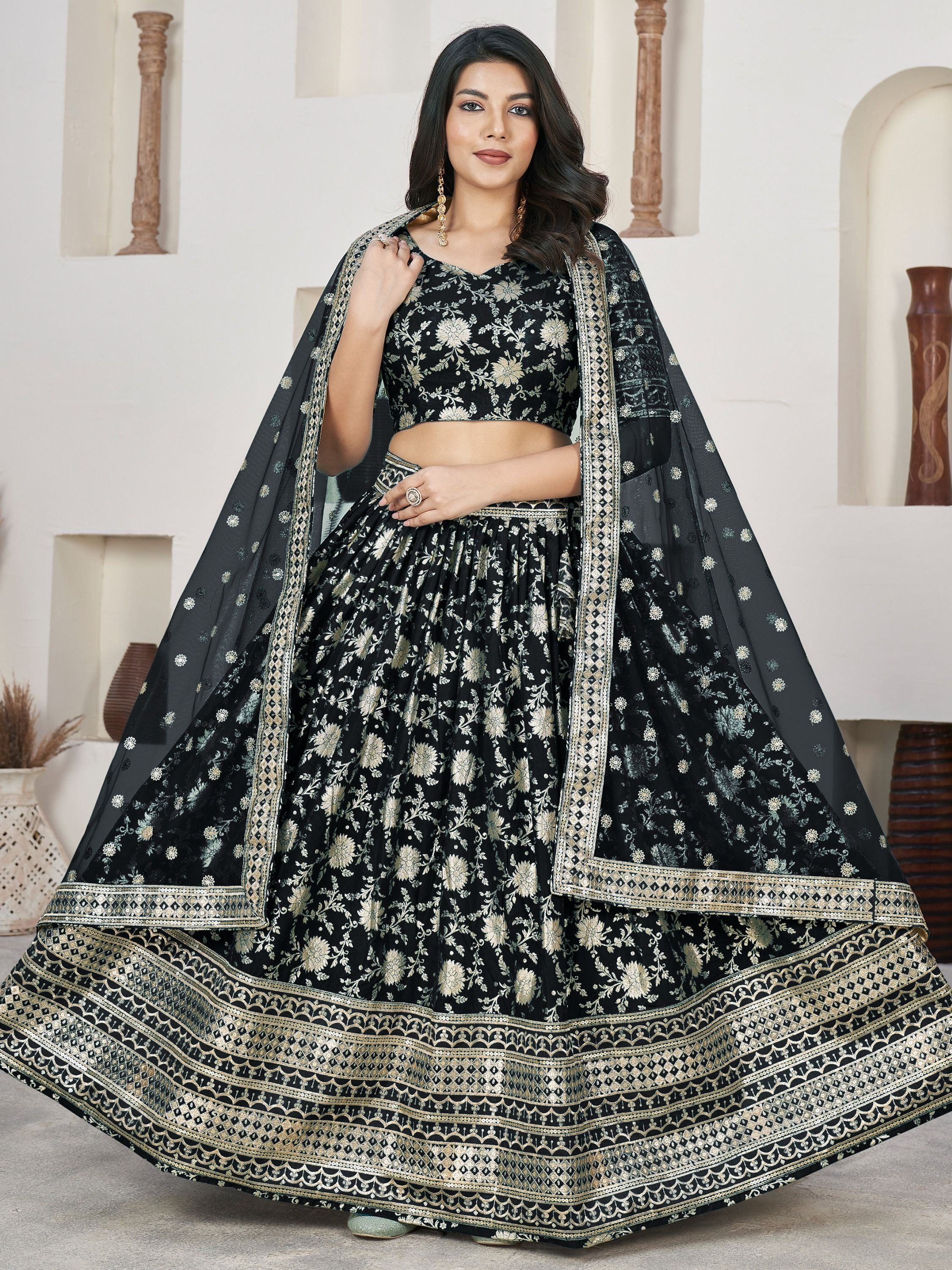 Black and gold embroidered lehenga choli with floral motifs and dupatta, ideal for Indian ethnic wear occasions.