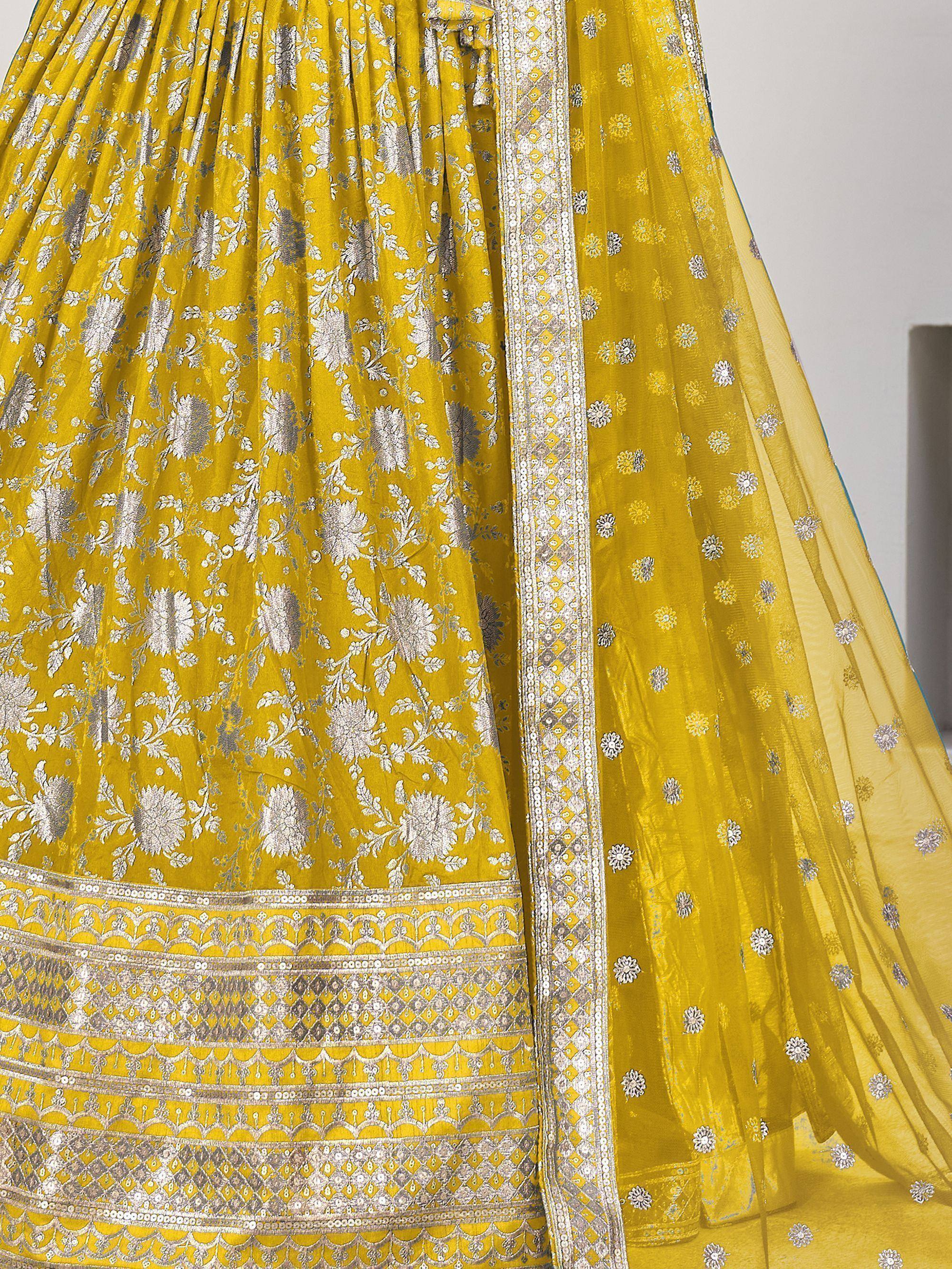 Yellow designer lehenga choli with silver floral embroidery and embellished border, ethnic Indian wear