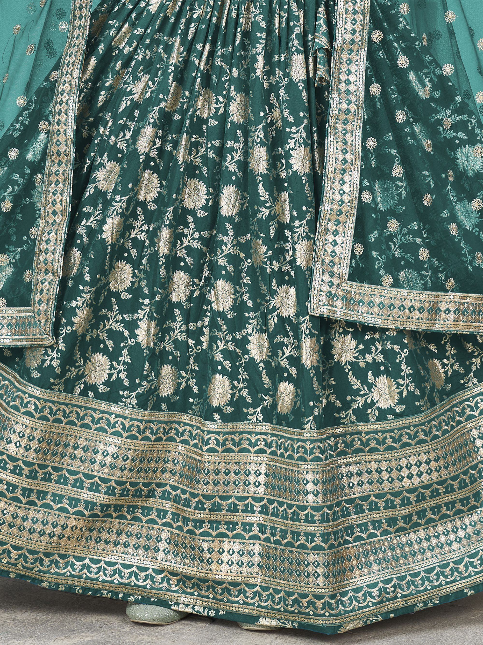 Emerald green lehenga choli with gold floral embroidery and intricate border detailing for Indian ethnic wear.