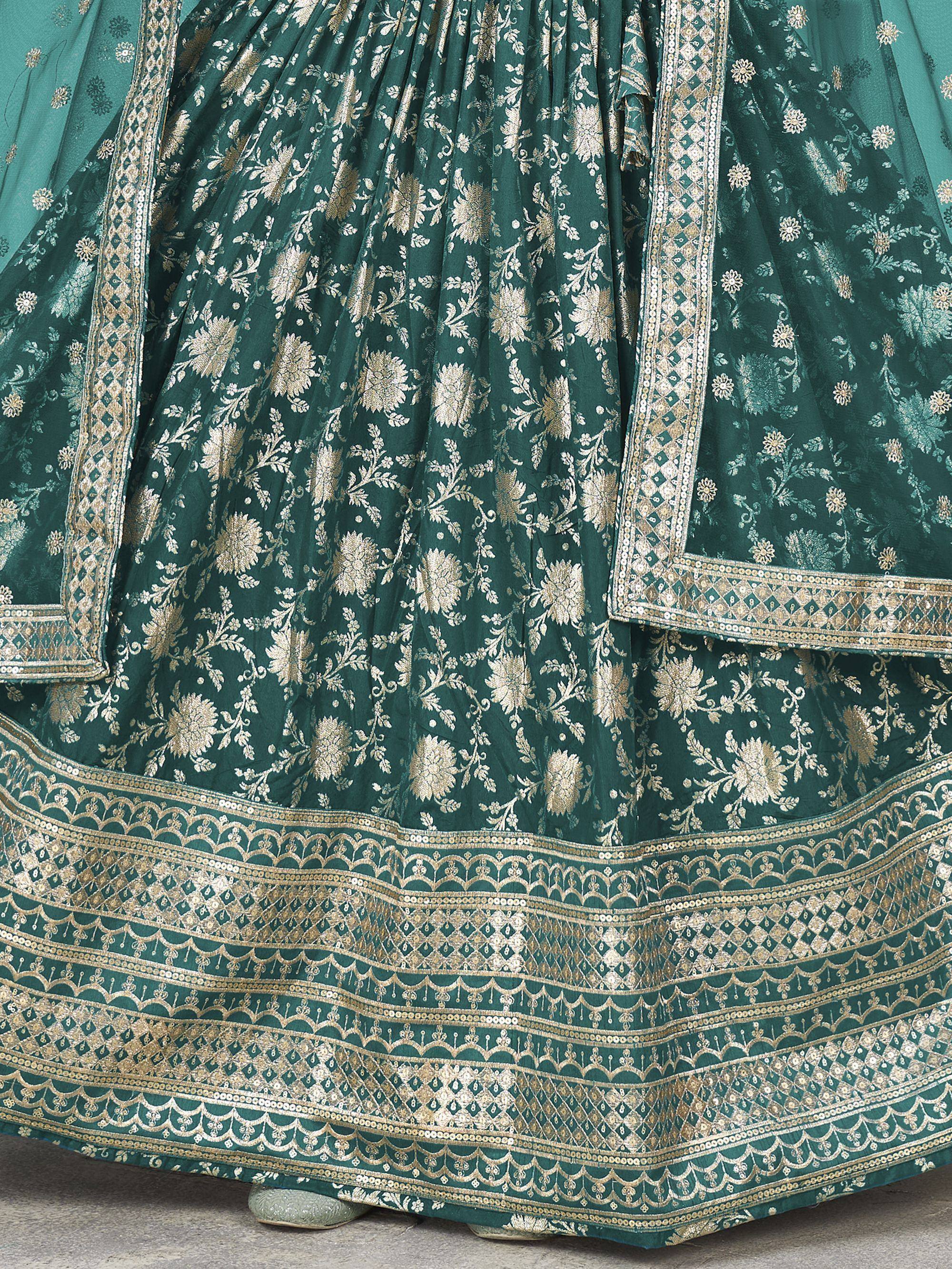 Emerald green lehenga choli with gold floral embroidery and intricate border detailing for Indian ethnic wear.