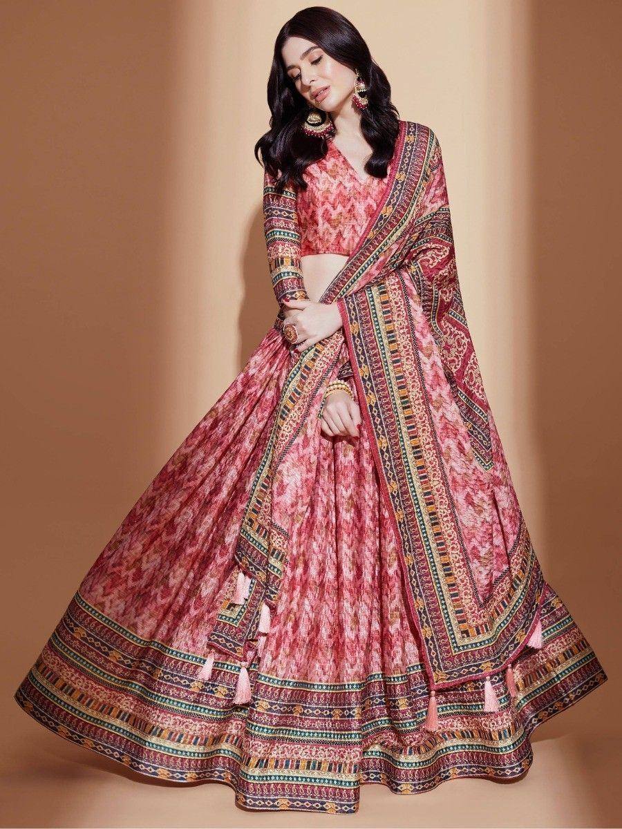 Pink printed lehenga choli with ethnic border and tassels, perfect for Indian weddings and festive occasions