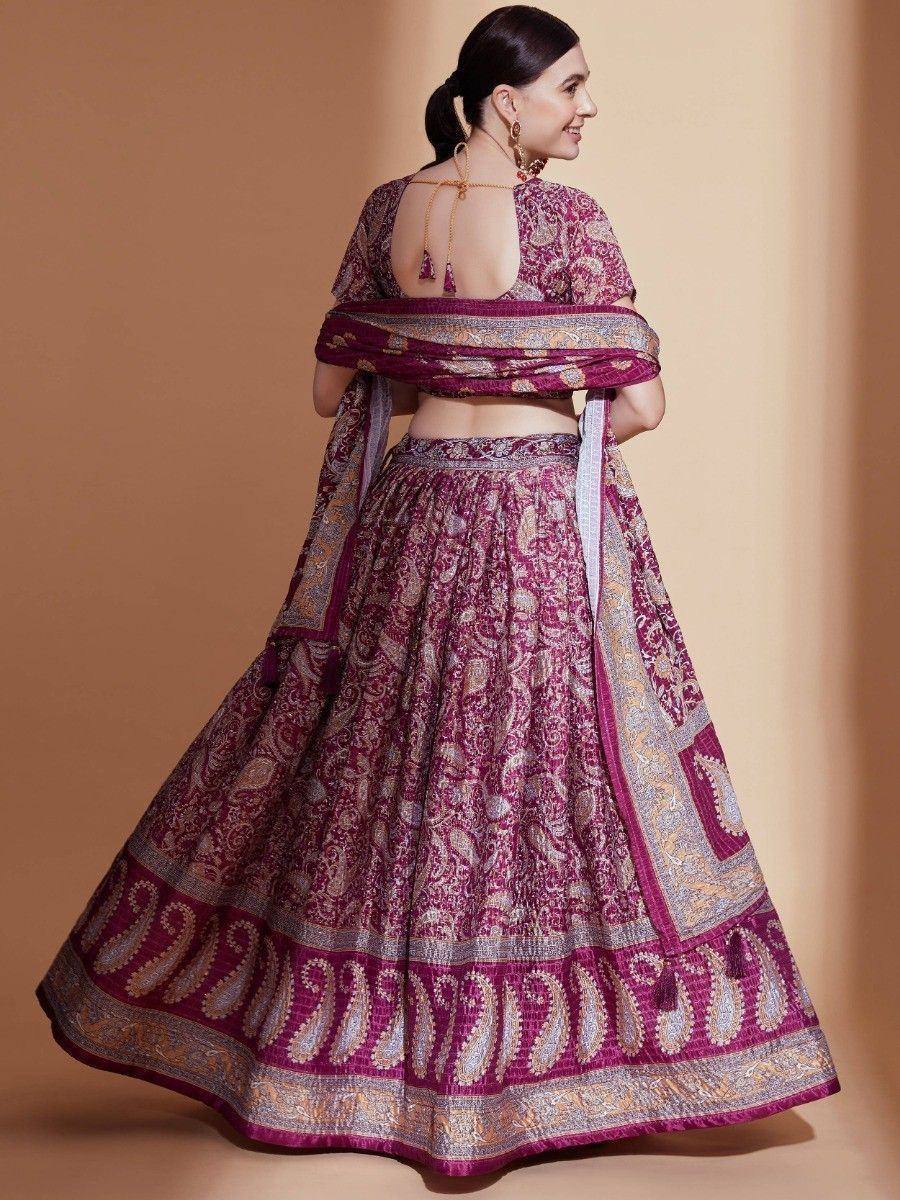 Elegant maroon lehenga choli with intricate paisley print and backless blouse, perfect for Indian ethnic occasions.