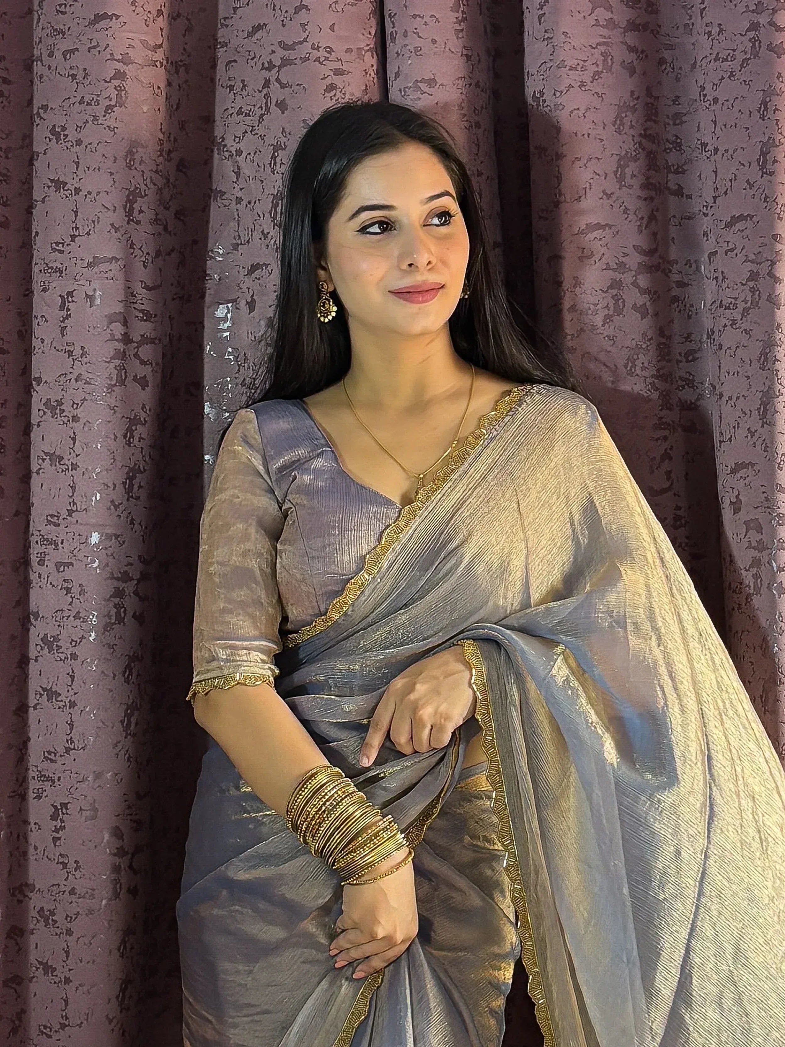 Woman in elegant grey saree with gold border, perfect for Indian ethnic wear occasions