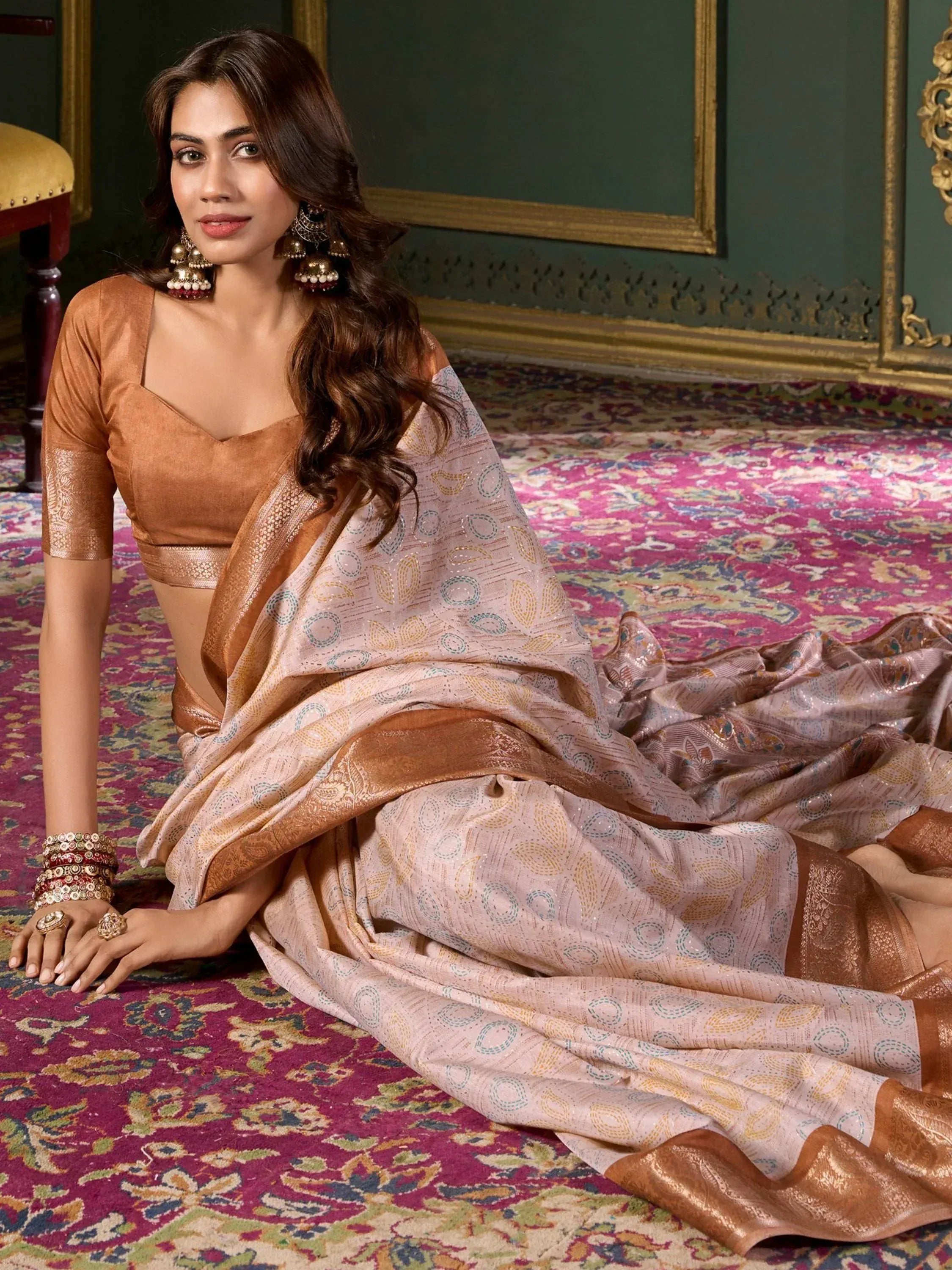 Woman in elegant beige and copper saree with gold patterns, traditional Indian ethnic wear