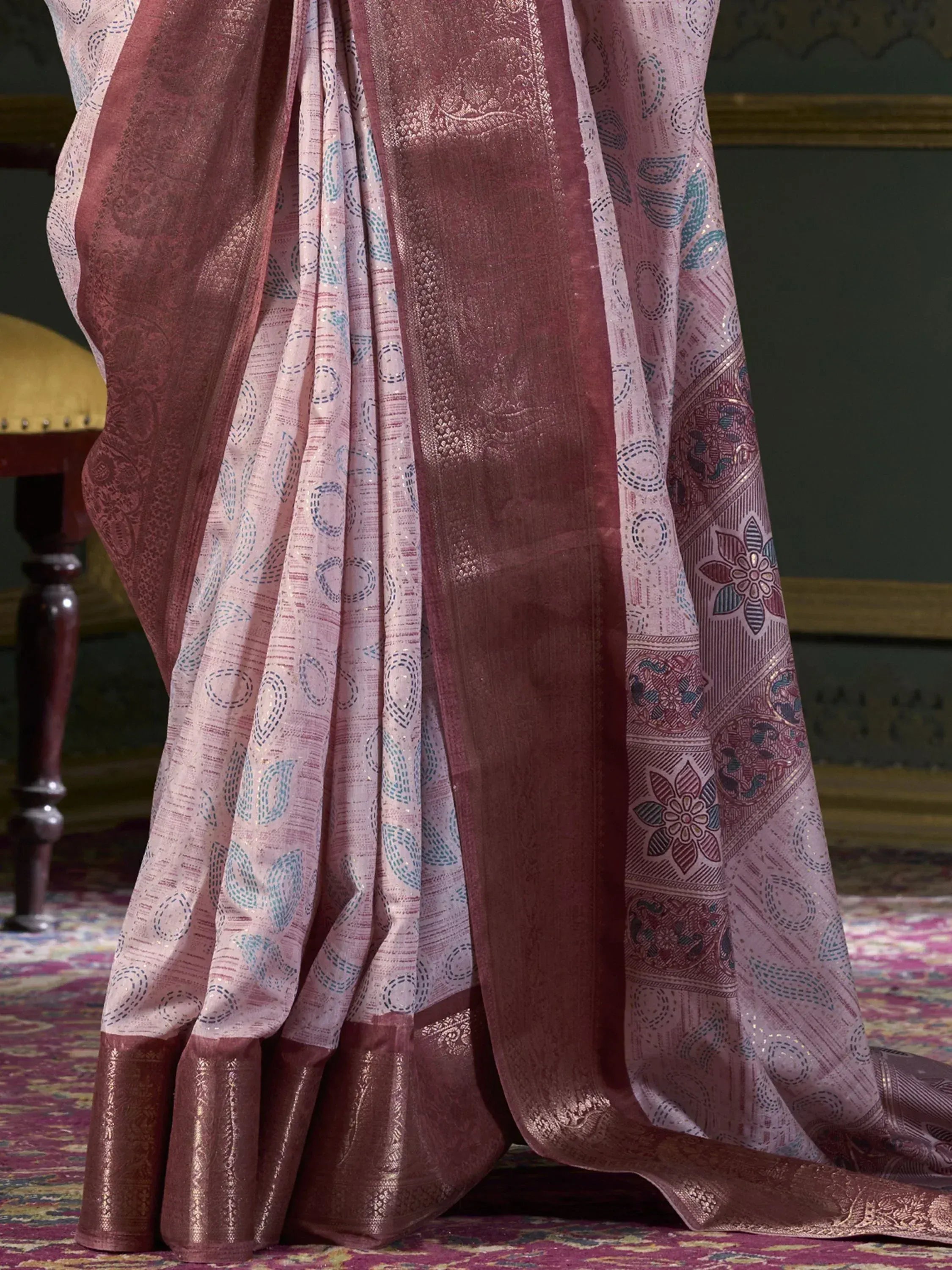 Pink and maroon designer saree with intricate floral and geometric patterns, perfect for ethnic wear