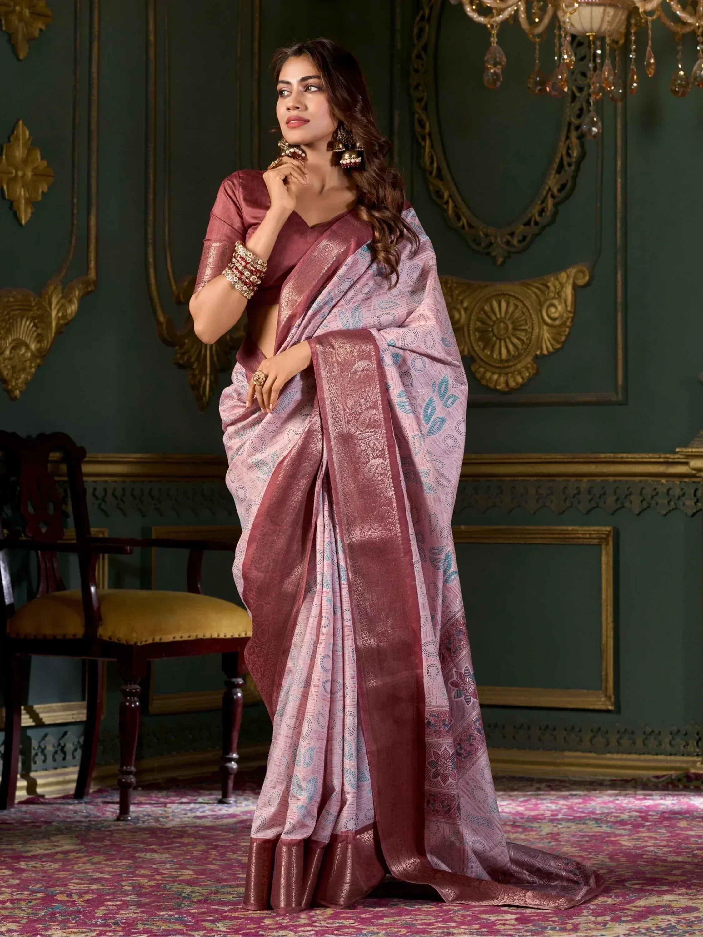 Elegant woman in pink and maroon printed saree with gold border, perfect for Indian ethnic occasions.
